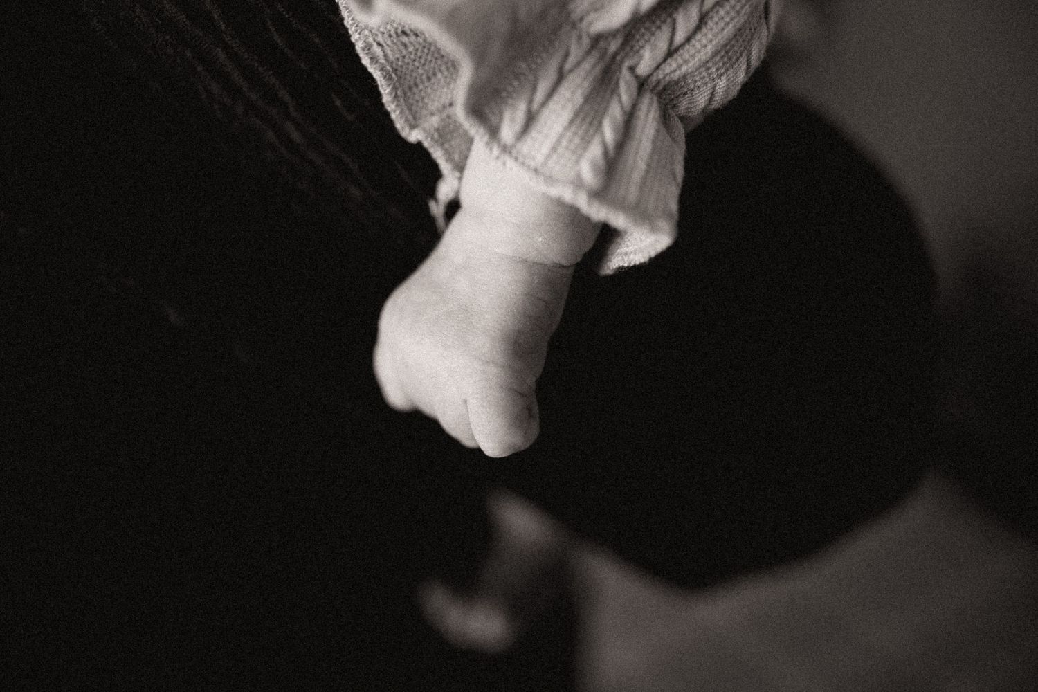 Black and white detail shots capturing intimate moments in dramatic lighting and shadows.