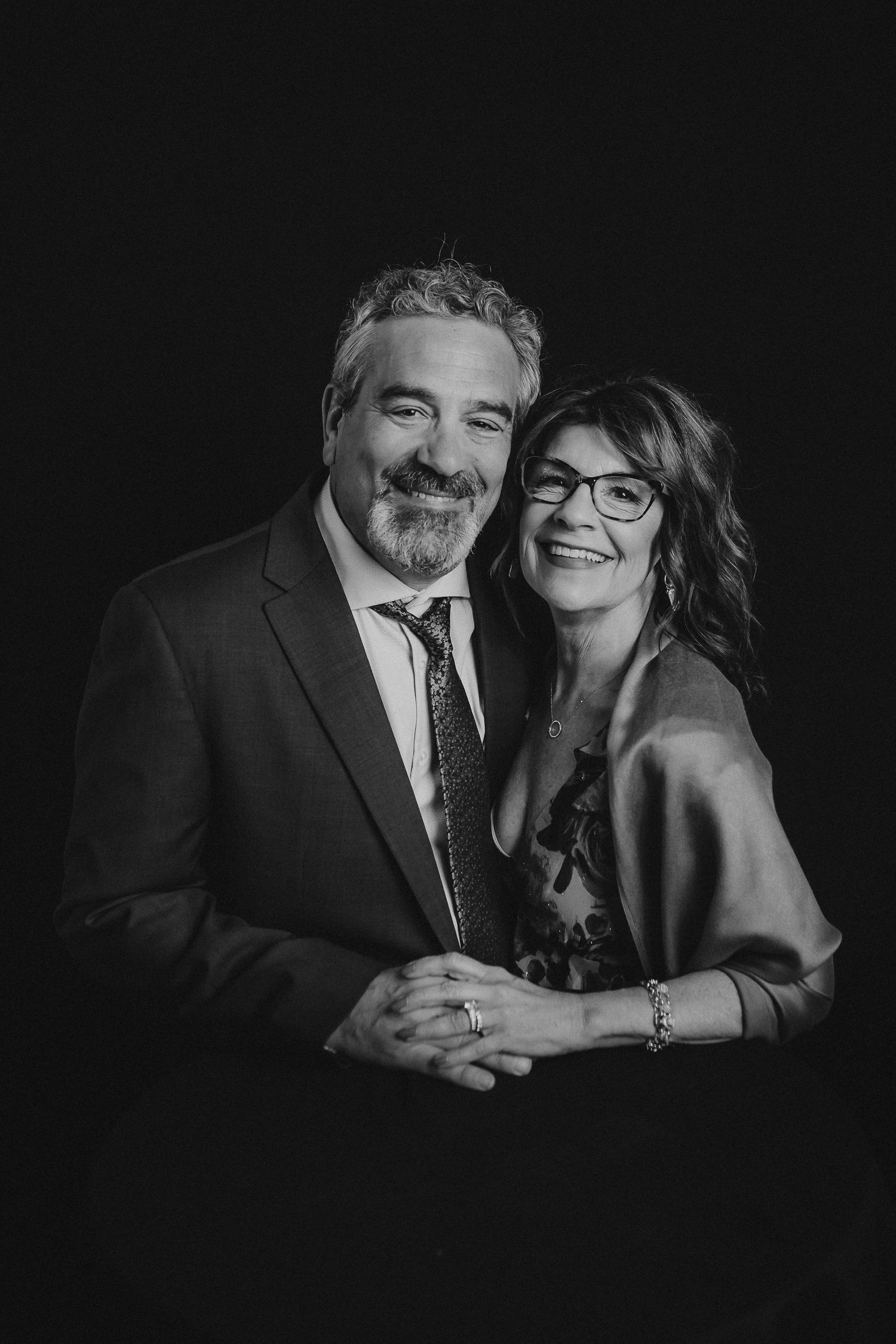 Elegant black and white portrait series showing romantic connection in formal attire.