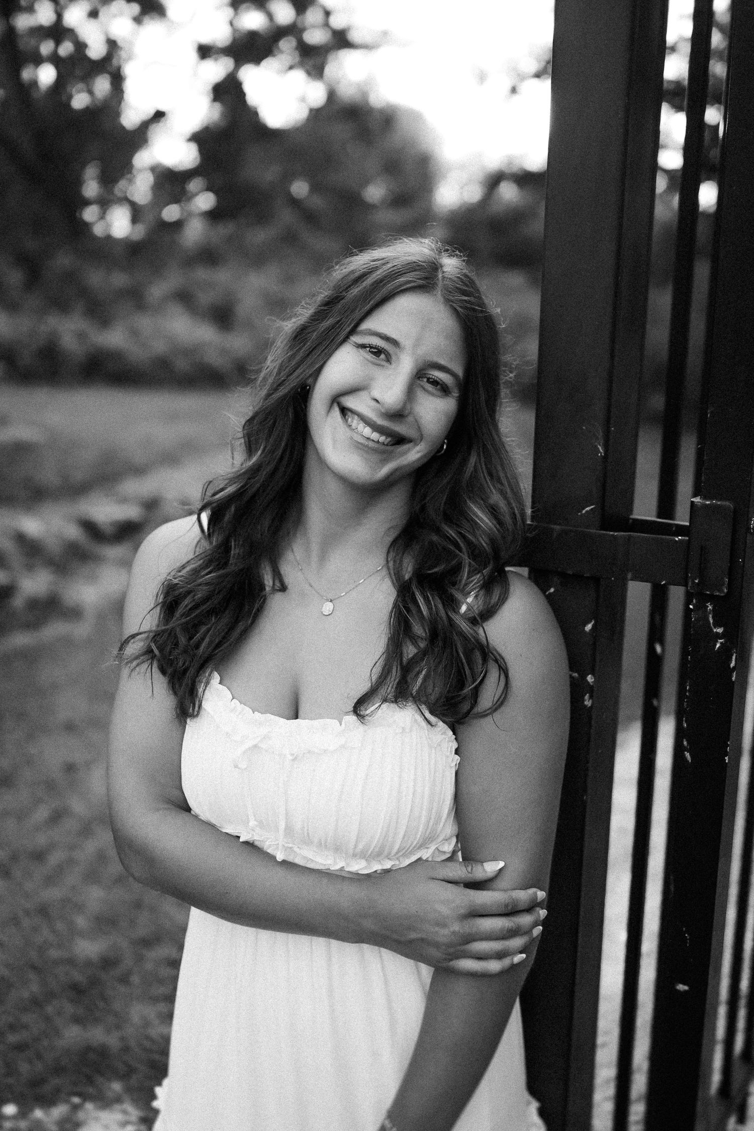 Black and white portrait series showing joyful expressions against outdoor background.