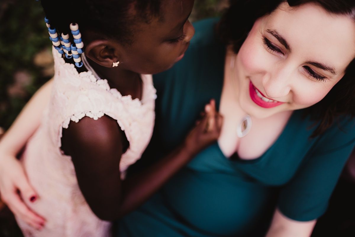 Close-up of intimate moment showing smiles and connection between adult and child.
