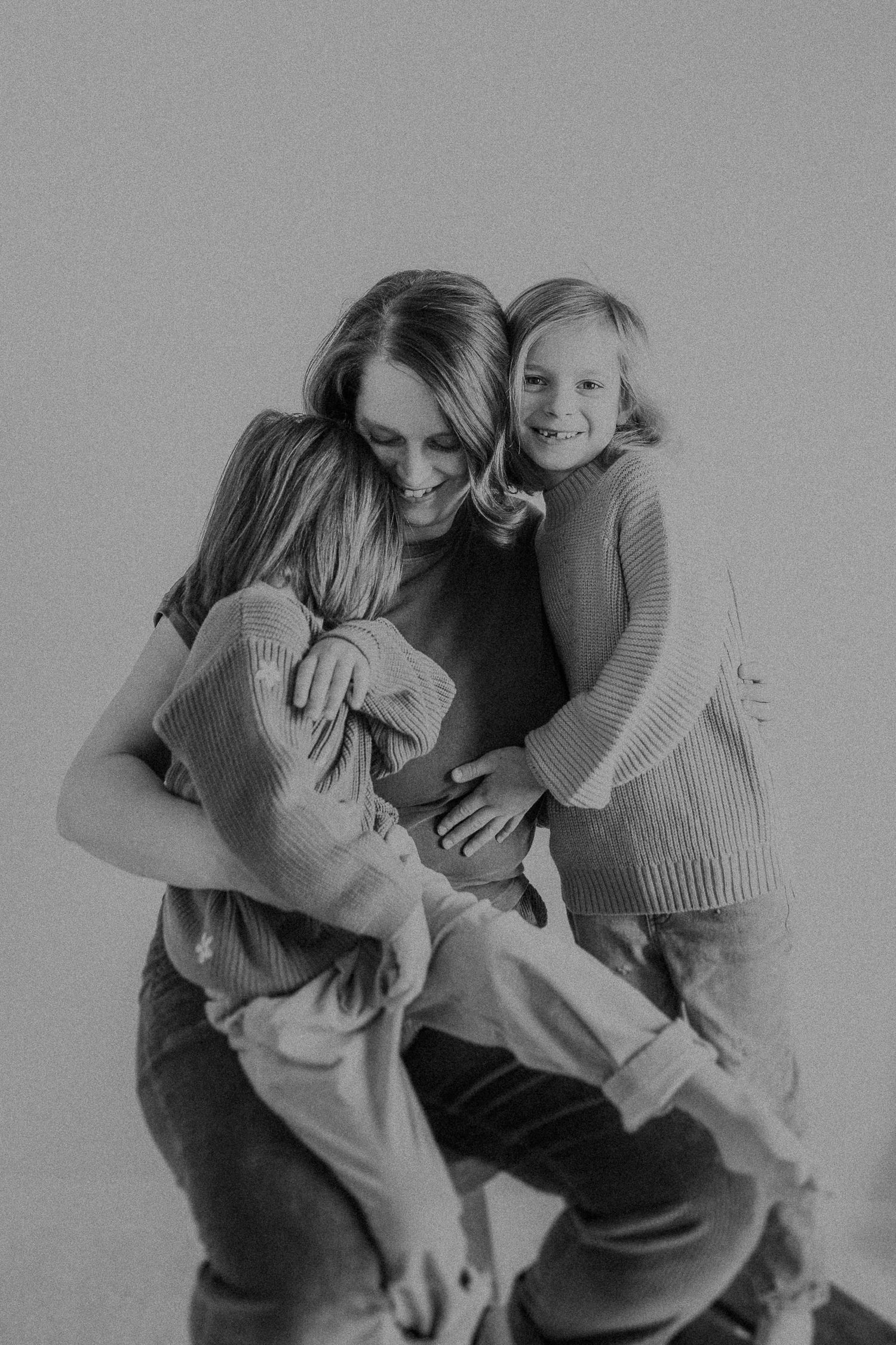 Intimate black and white photograph showing playful interaction and laughter.