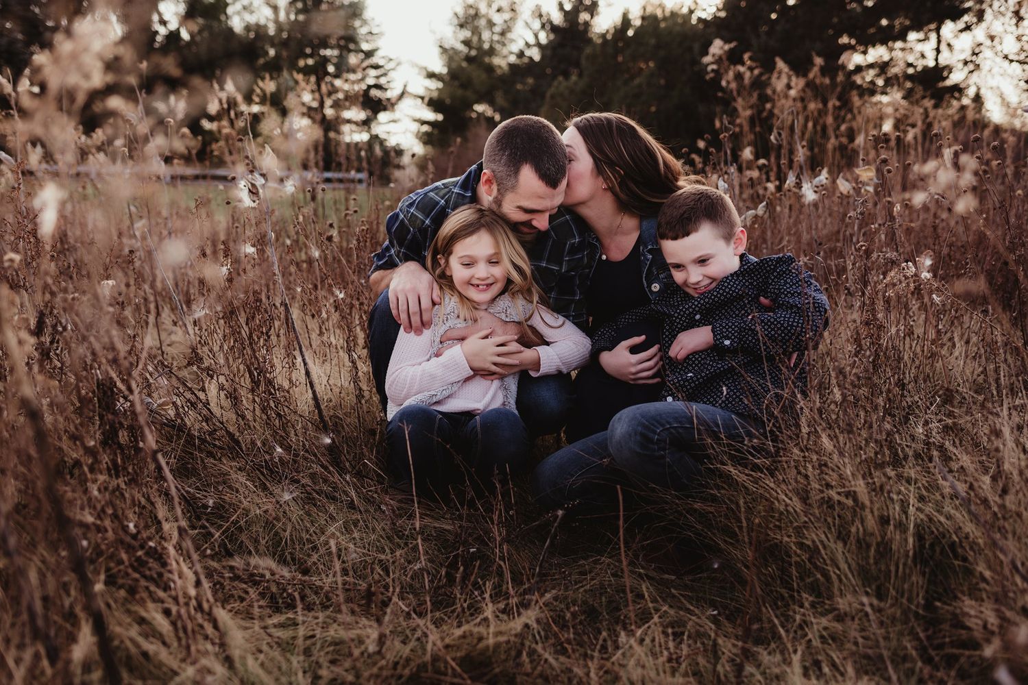 An intimate family portrait showing joyful interaction in a natural setting.