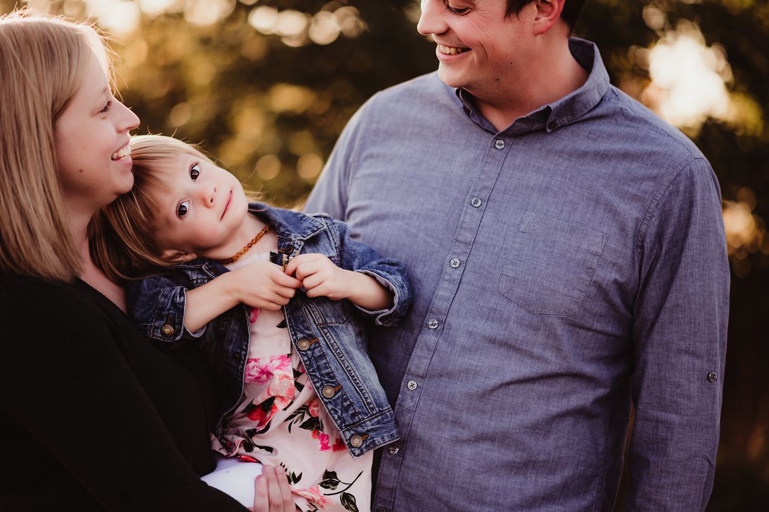 Candid family moment captured during sunset with warm lighting.