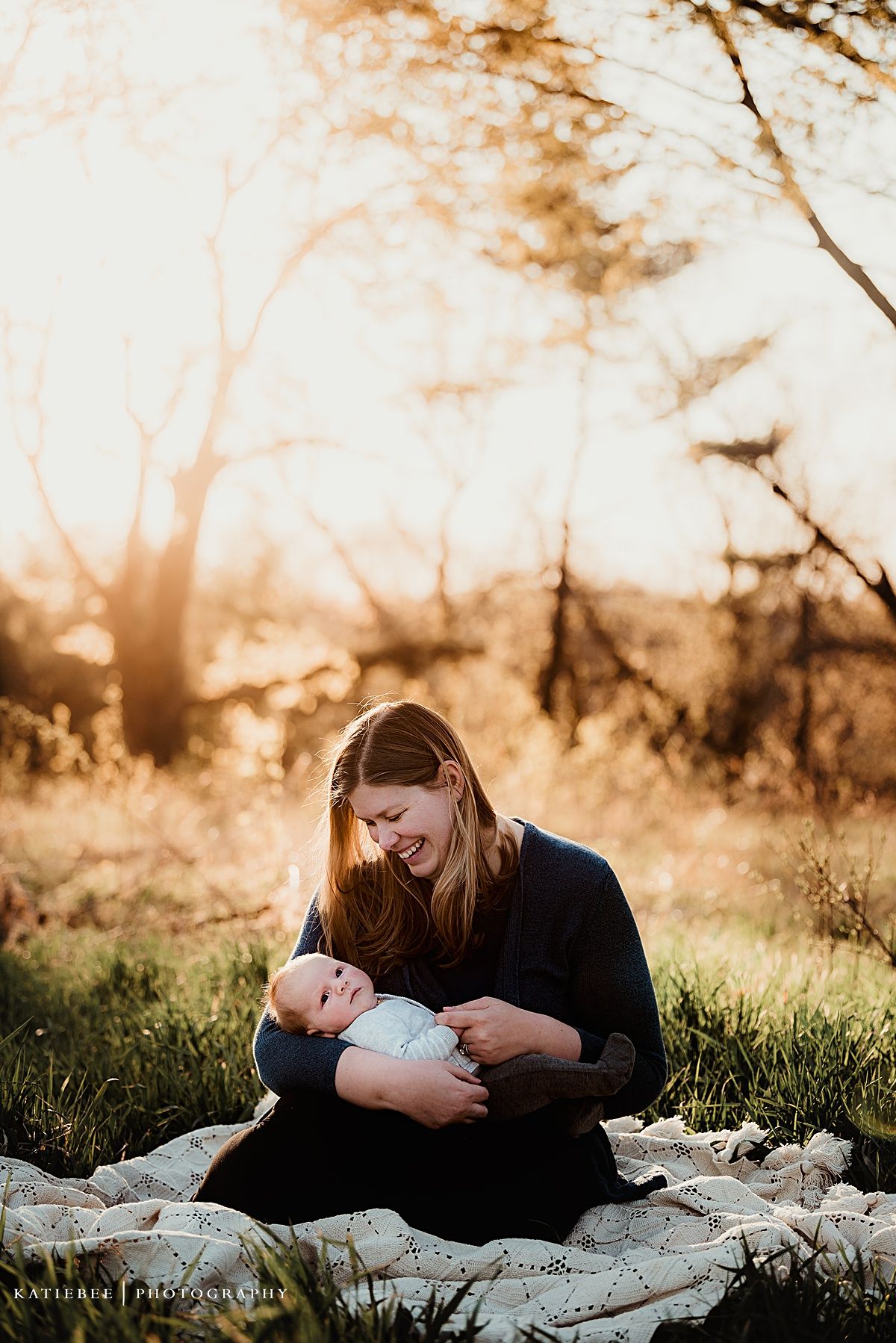 Sunset outdoor photo session showing loving interaction on a blanket in nature.