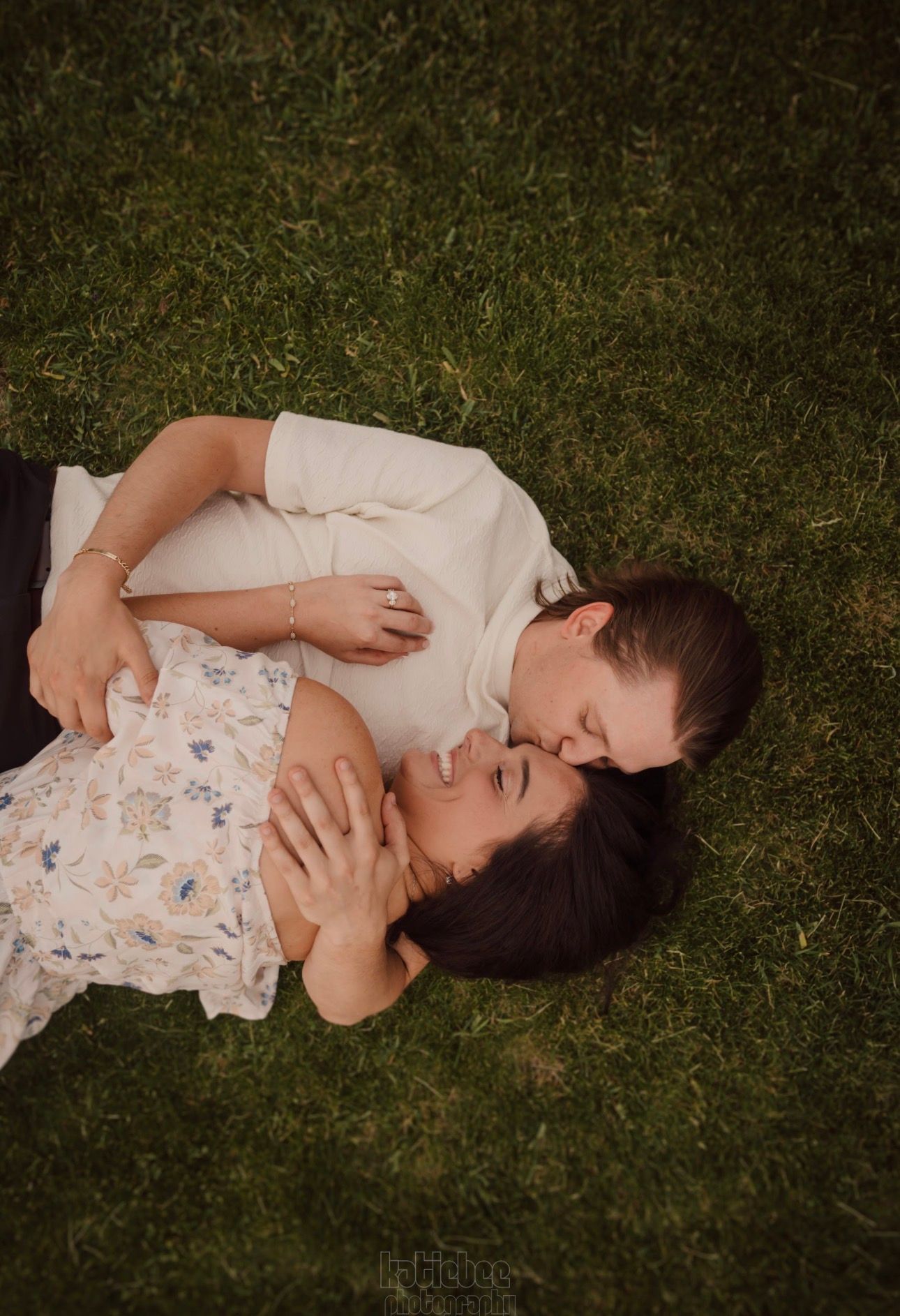 A peaceful moment captured of someone lying in soft grass wearing white.