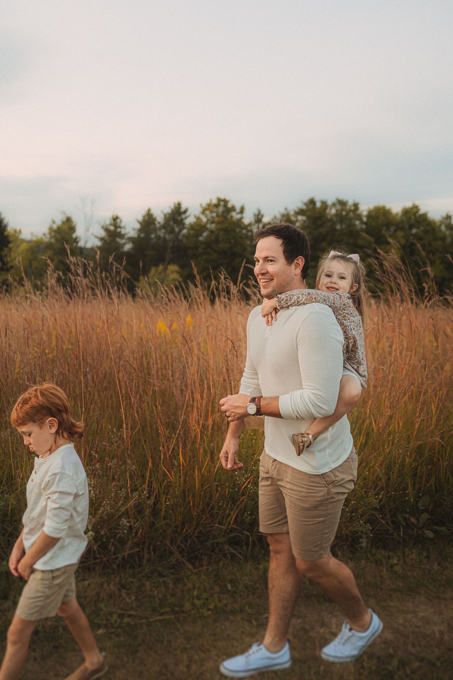 A peaceful evening walk through a field of tall grass with sunset lighting.