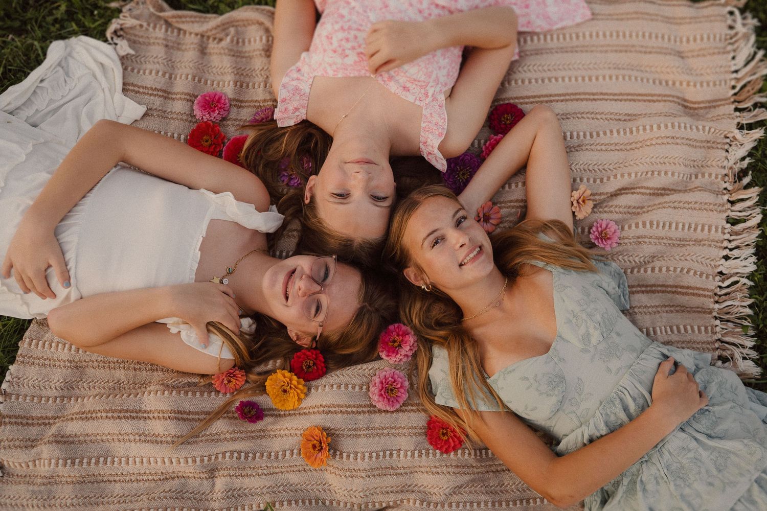 Series of people lying on a cozy gray couch with colorful flowers scattered around in a relaxed setting.