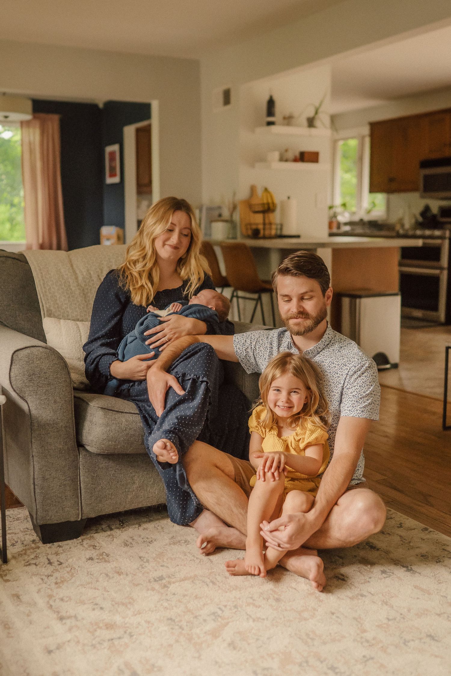 A cozy family moment in a living room with natural light streaming through windows.