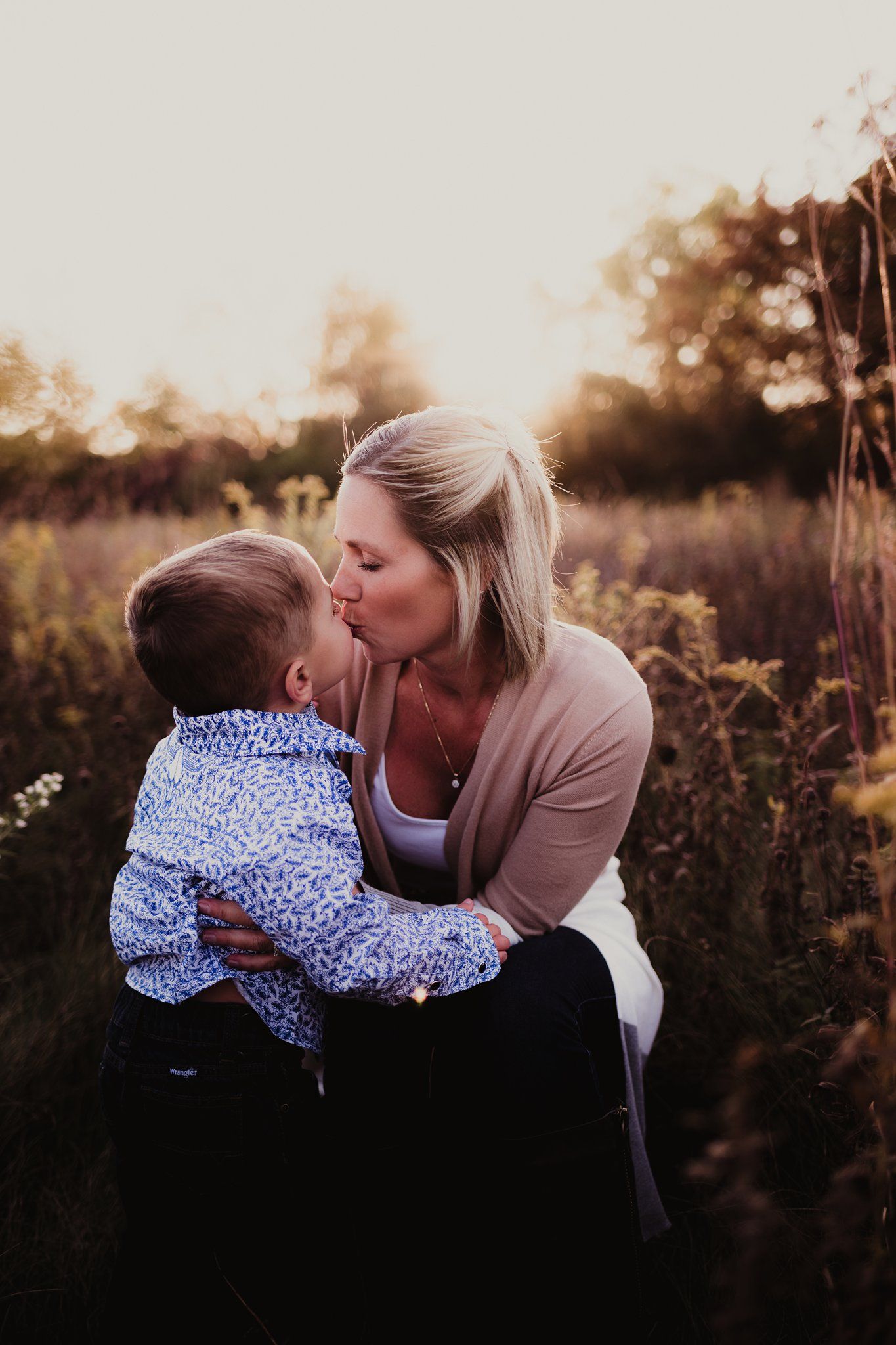 An intimate outdoor portrait showing affection in a natural setting.