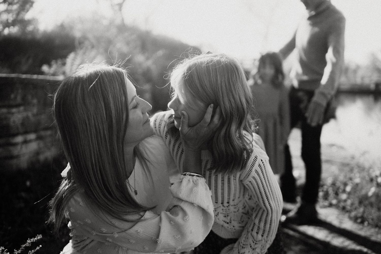 A black and white photo montage showing intimate romantic moments between a couple in various outdoor settings.