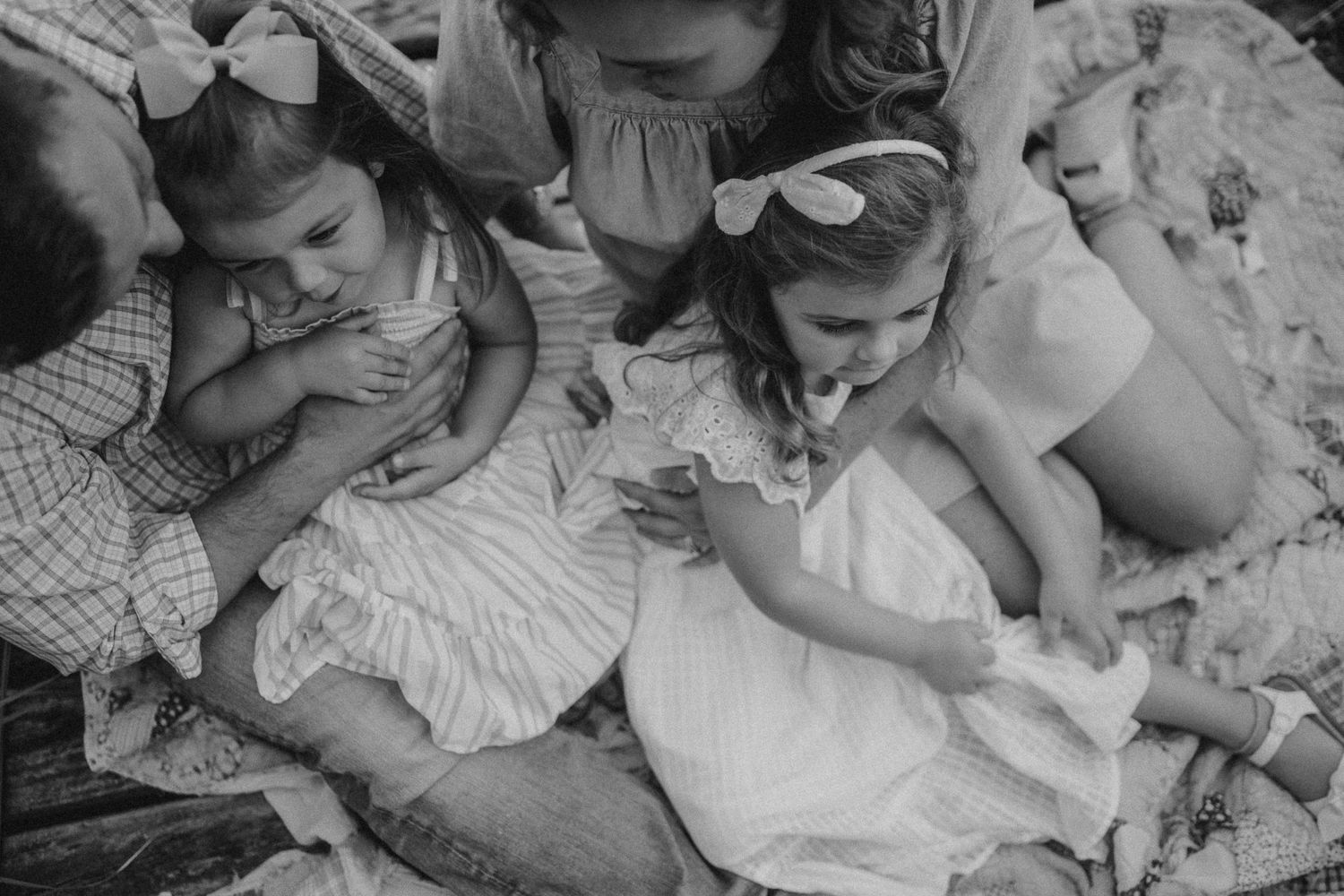 Black and white intimate portrait of family members sharing a tender moment together.