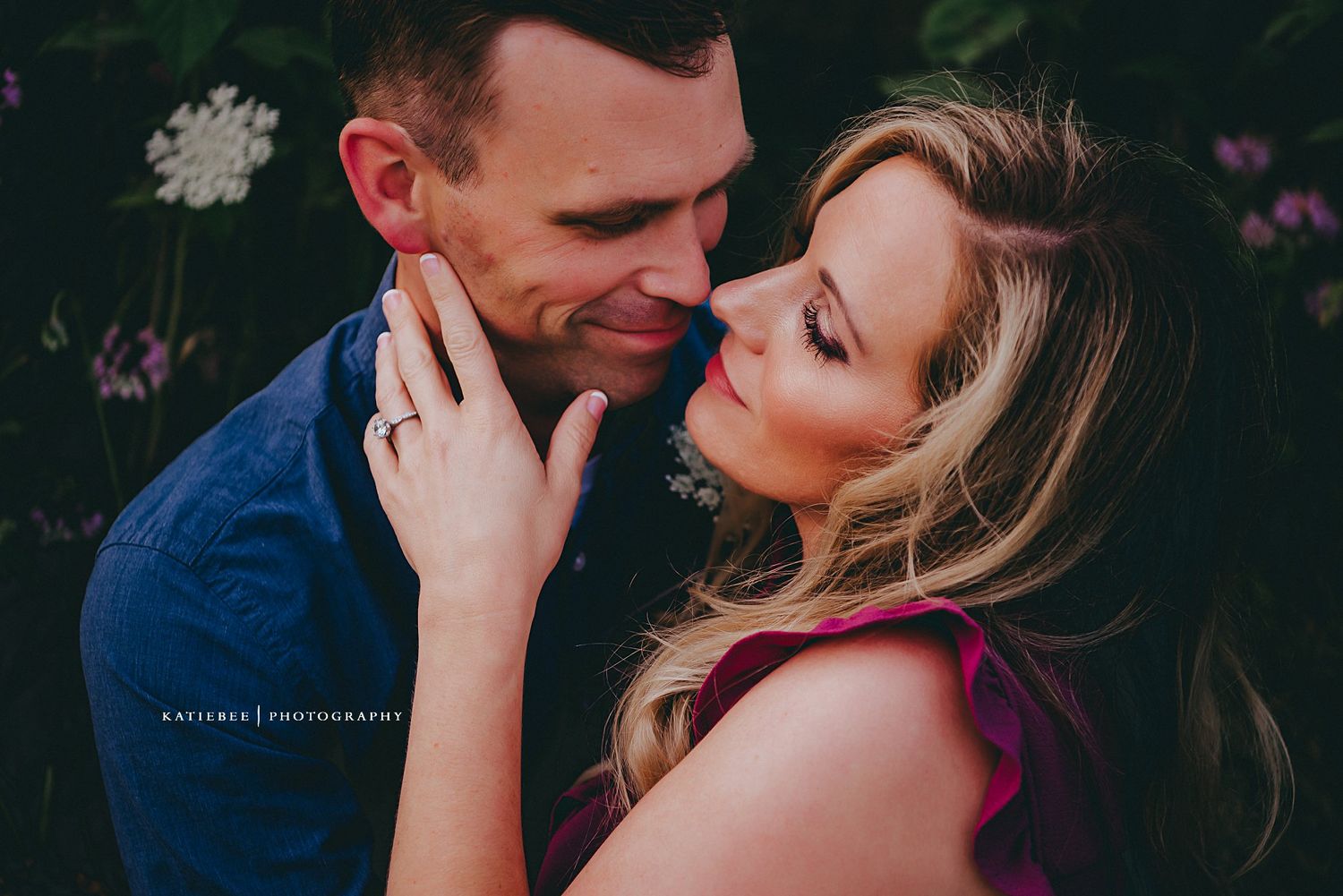 An intimate moment captured between a couple during an outdoor engagement photoshoot.