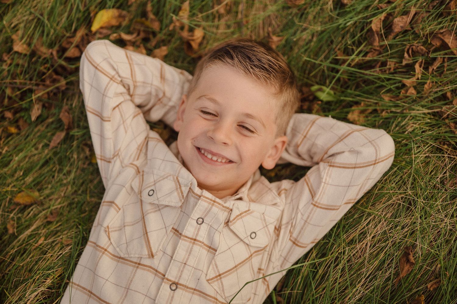 A sequence of photos showing a person lying in tall grass with their hands behind their head in a relaxed pose.