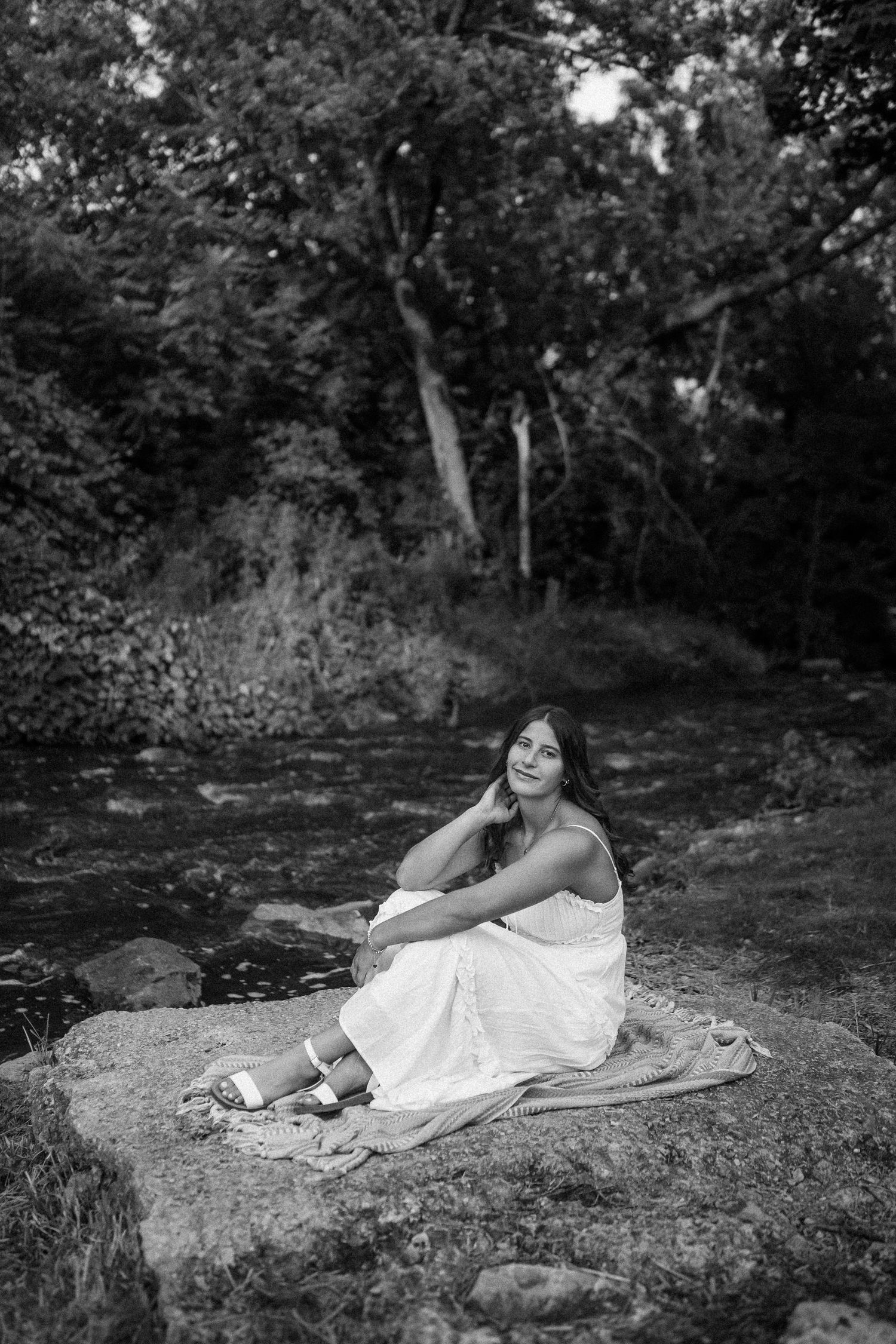 A white sundress against a black and white natural backdrop on a large rock formation.