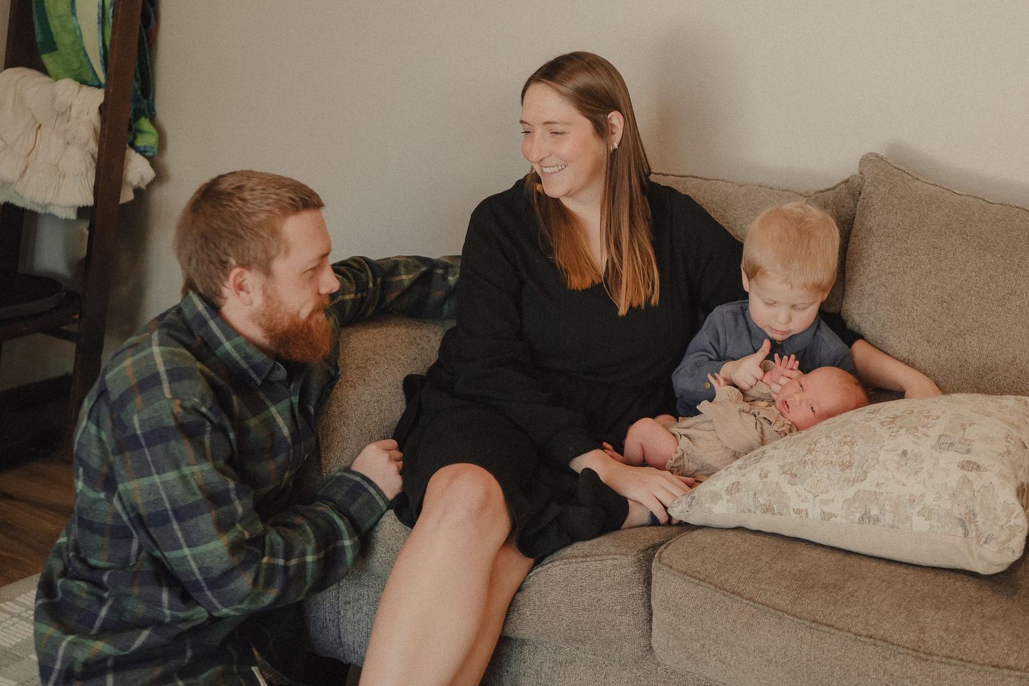 A series of intimate family photos showing tender moments between parents and children on a couch at home.