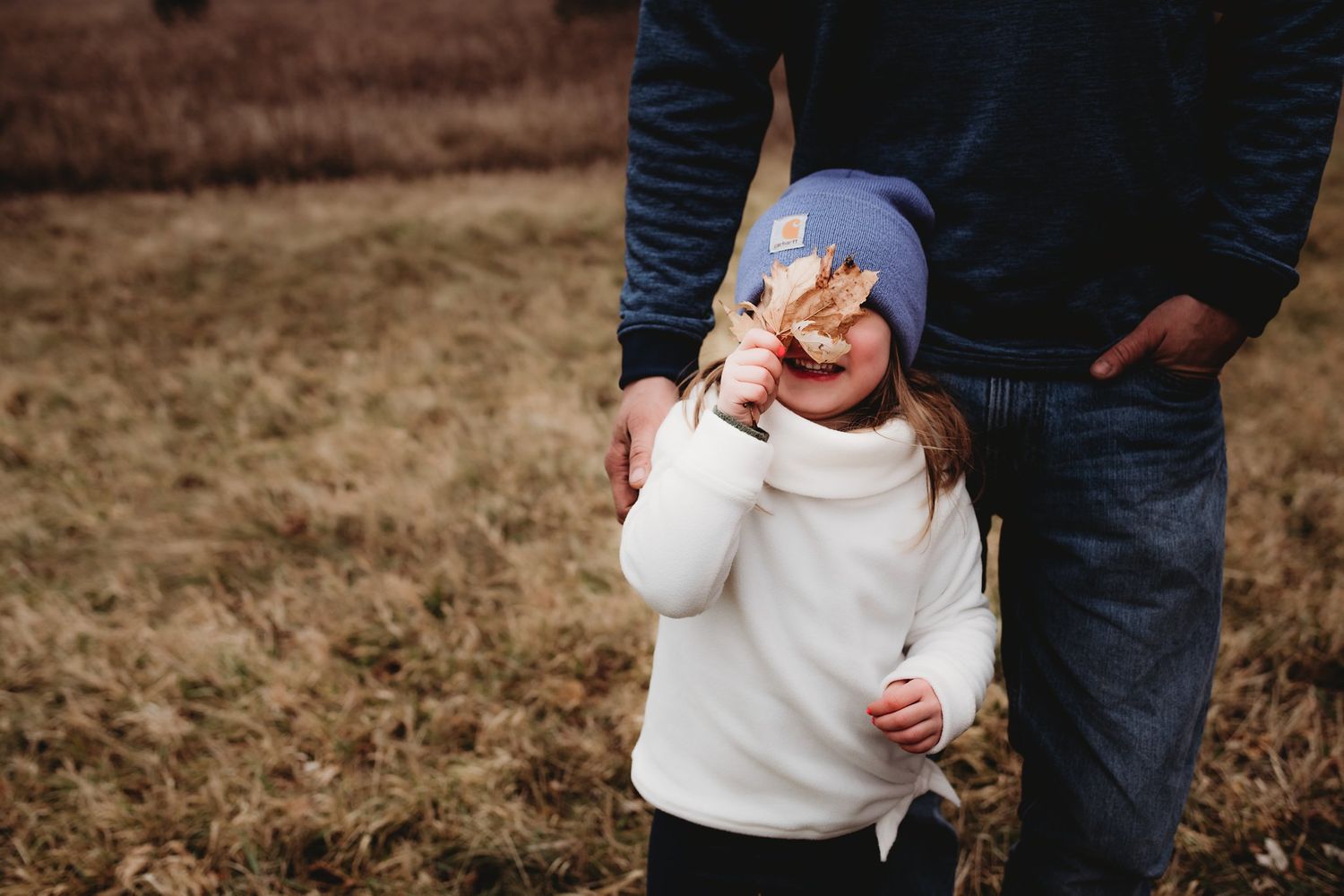 Candid moment captured of playful interaction wearing winter clothing outdoors.