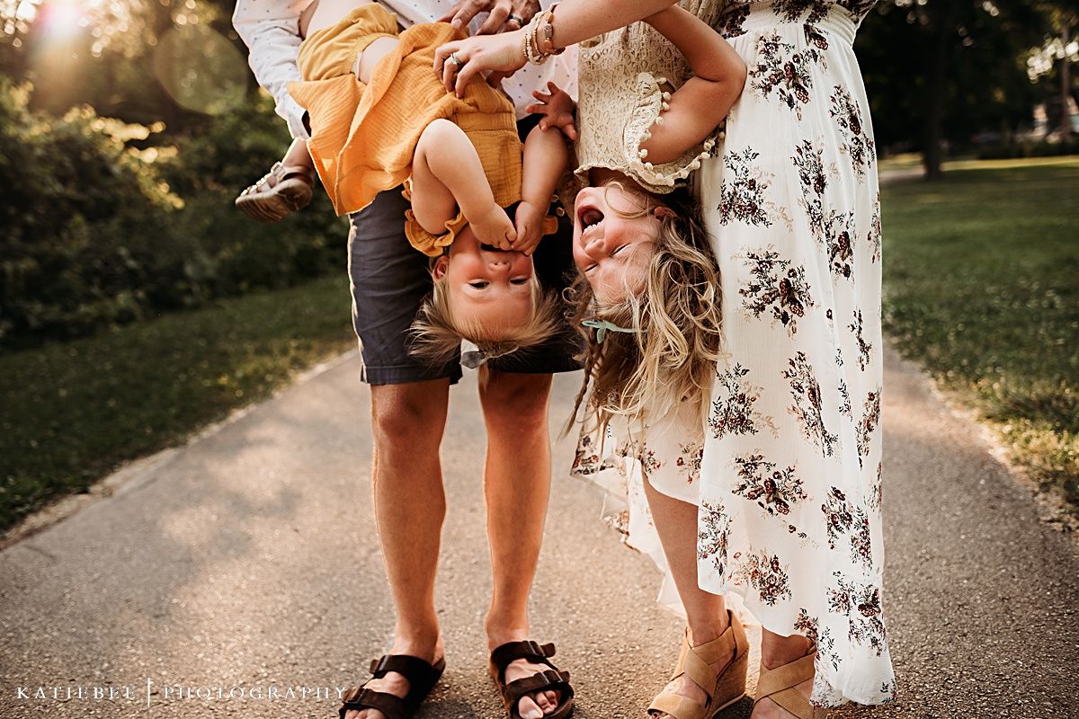 Candid family moment captured from behind on walkway during sunset.