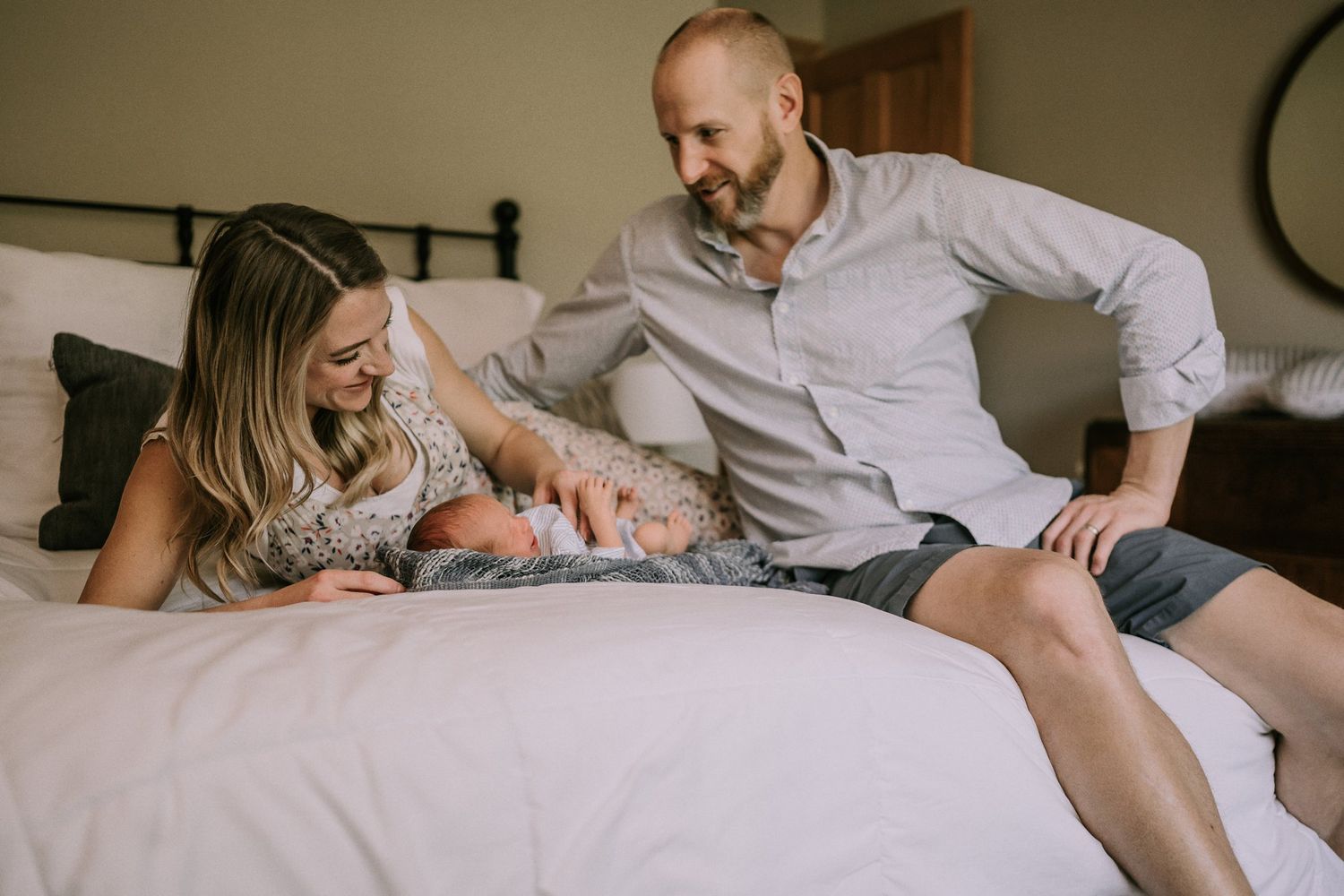 A family sharing a tender moment together while relaxing on a bed.