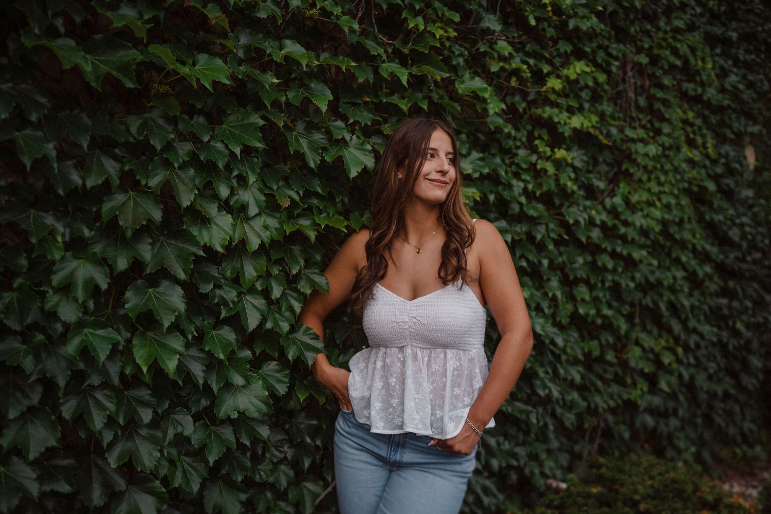 Portrait series against green ivy backdrop showing casual summer style.