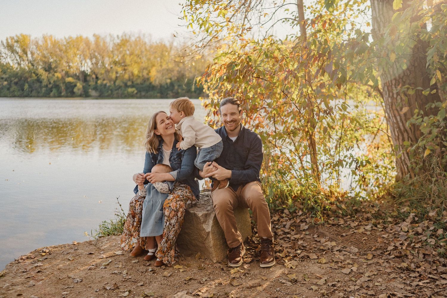 A joyful black and white family photo of people playing together in a field.
