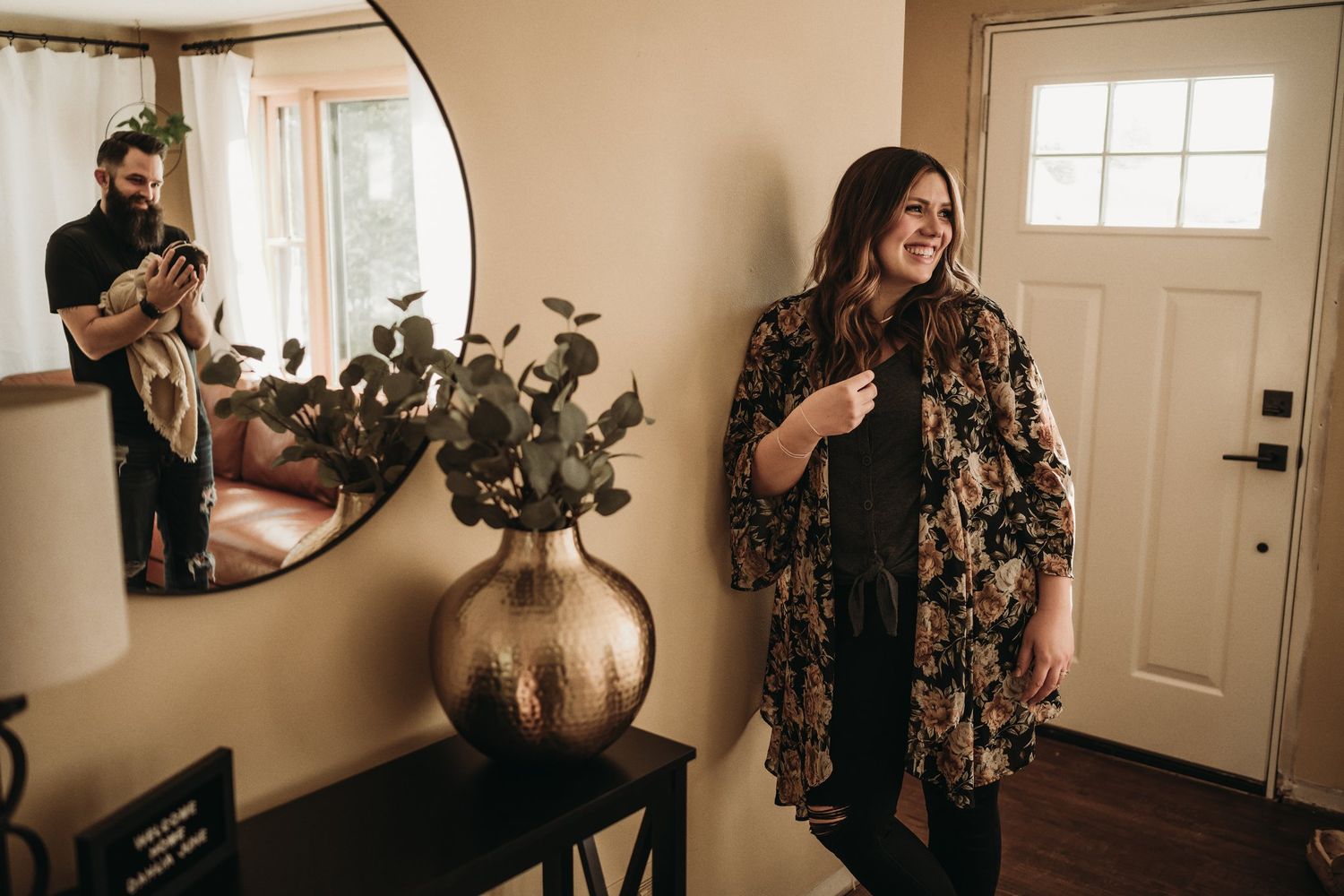 Casual indoor home scene with floral kimono and decorative entryway mirror.
