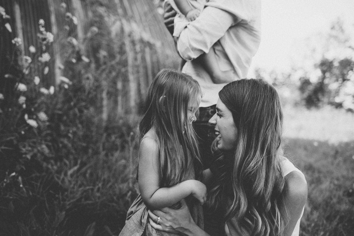 Black and white intimate portrait of a tender moment shared outdoors.