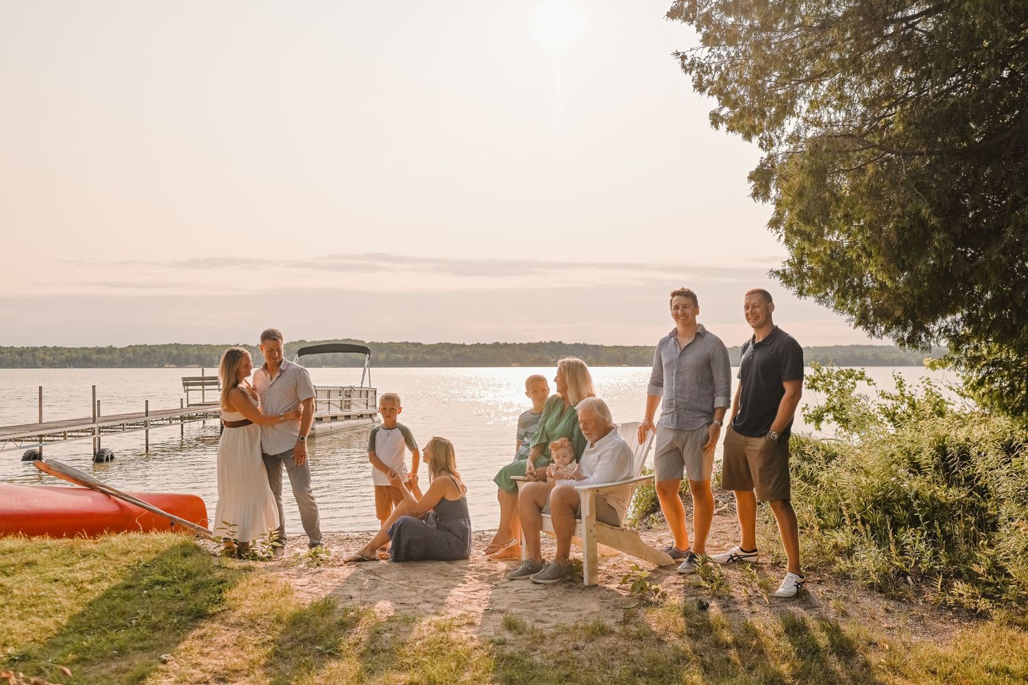 Family and friends gathered at sunset overlooking peaceful lake views.