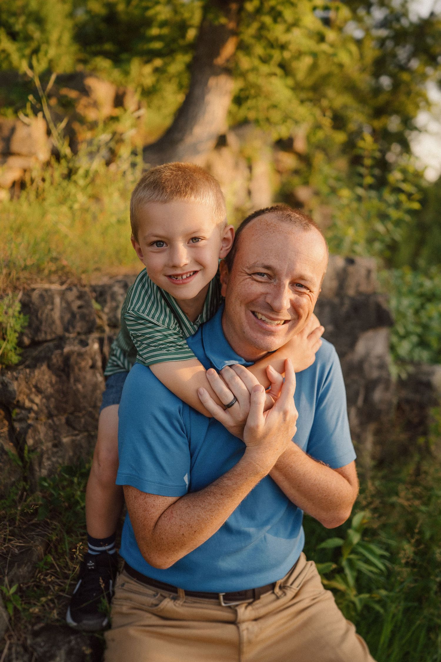 Joyful hugs and laughter shared during outdoor family photo session.