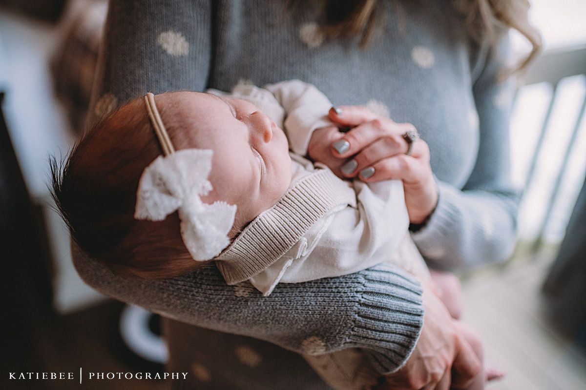 Intimate family portrait with soft winter lighting and cozy sweaters.