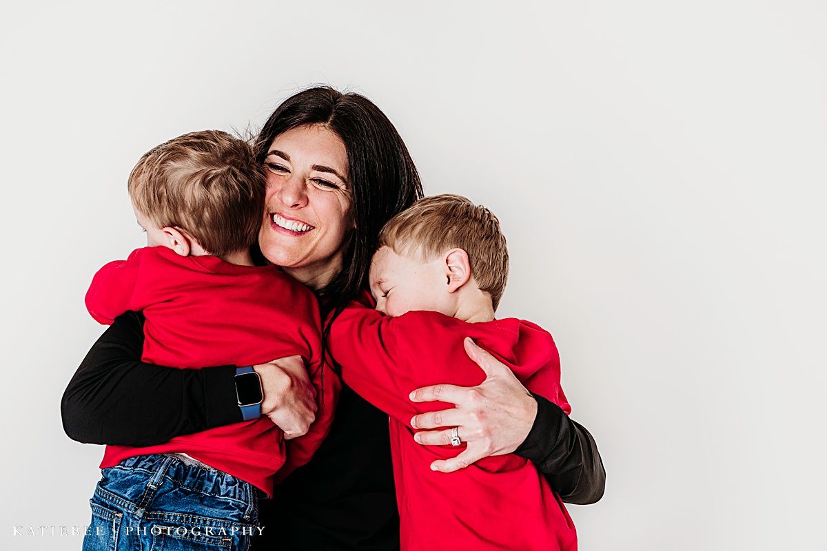 Happy family moment with embraces and smiles against white background.