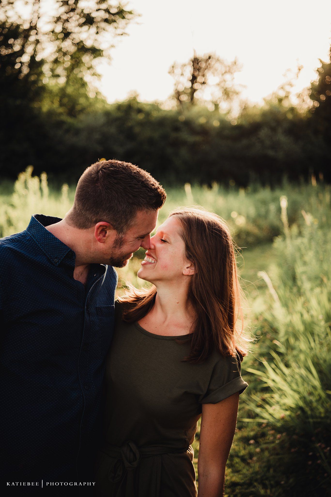 Intimate close-up of a couple sharing a tender moment in natural lighting.
