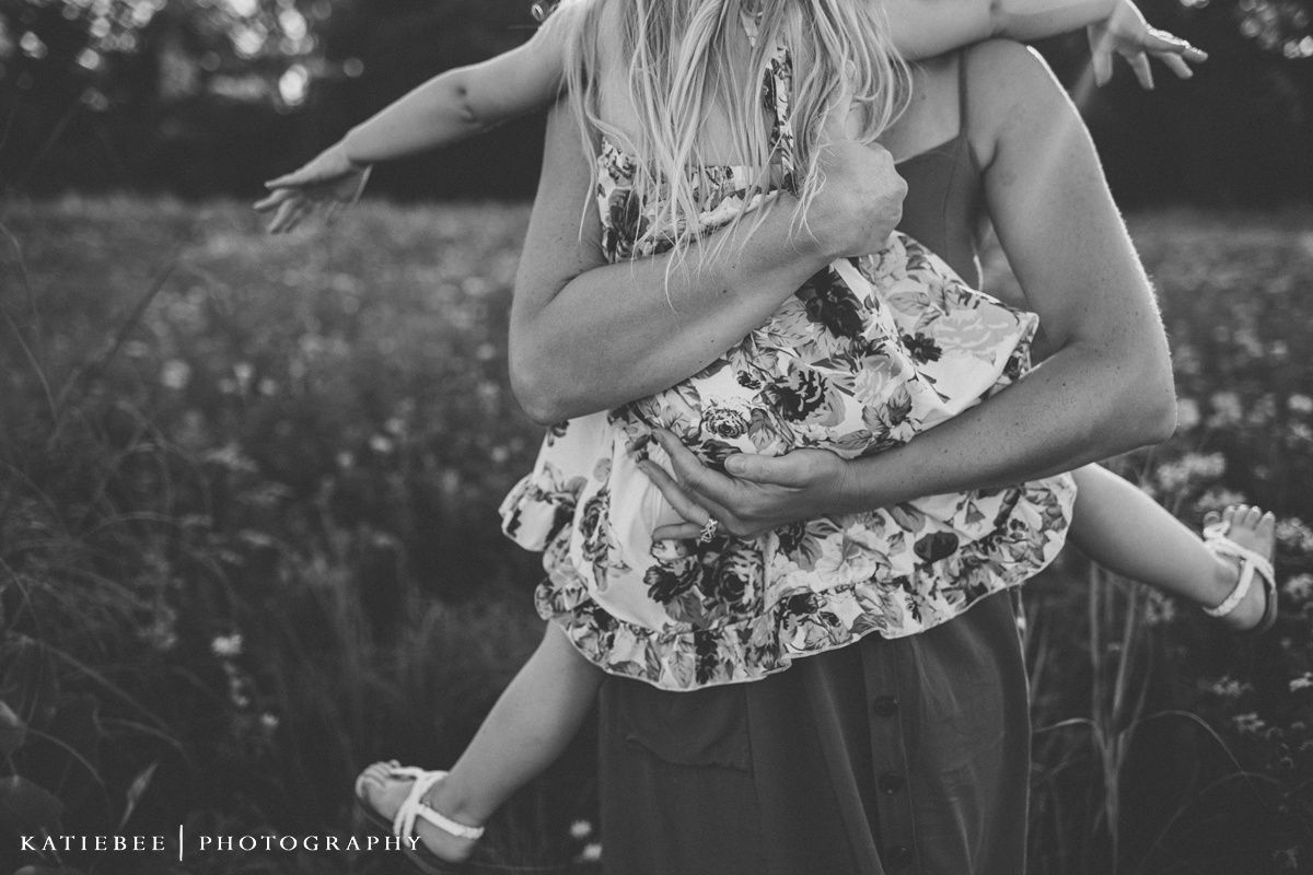 Black and white capture of a playful dance in a summer meadow.