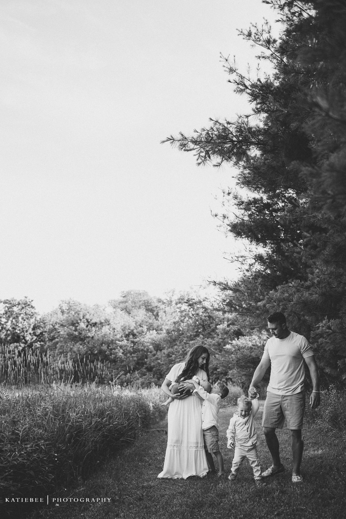 Beautiful black and white family photo taken on a scenic walking trail.