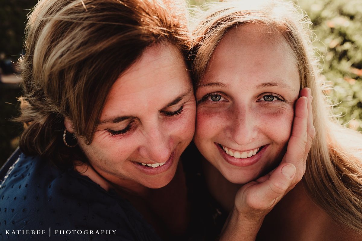 Close up portrait of two people sharing an intimate moment outdoors.