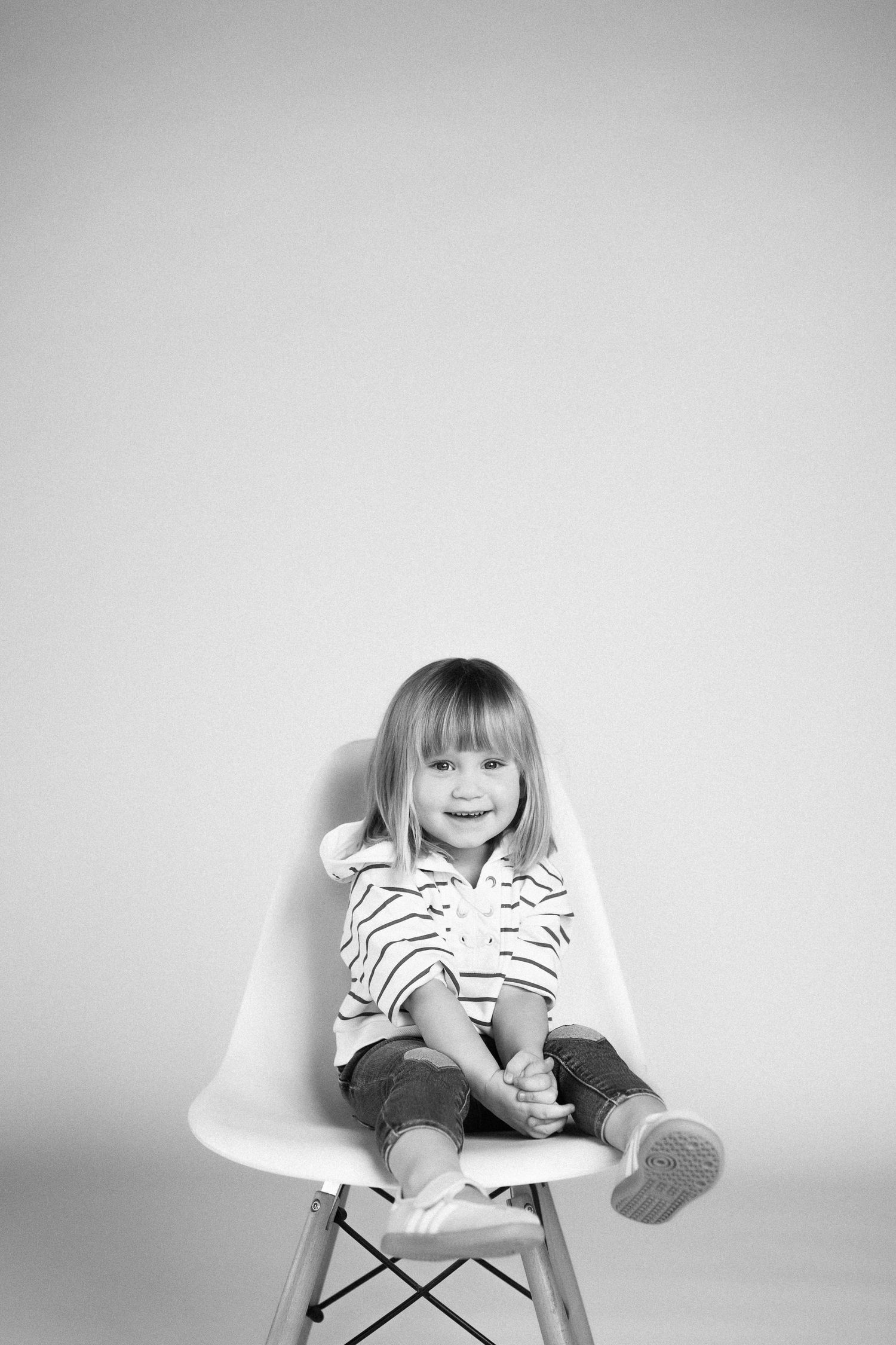 A sequence of black and white photos showing a child sitting and reading a book in different positions.