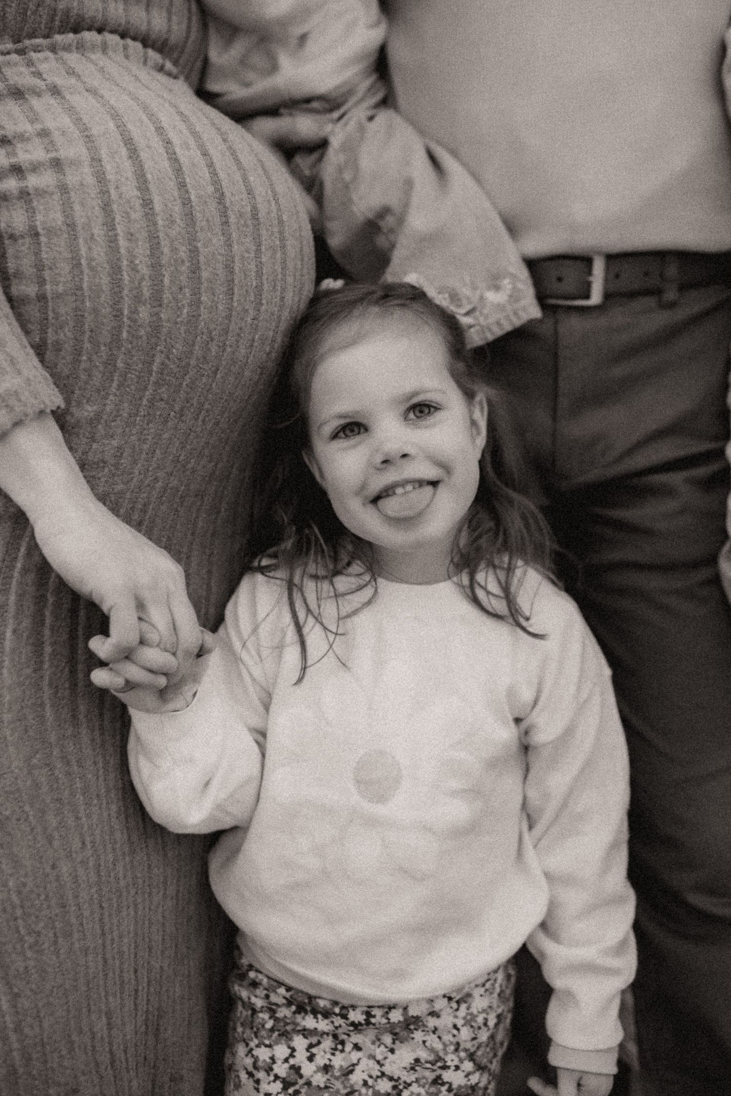 Close-up sequence showing joyful expressions and genuine smiles in black and white.