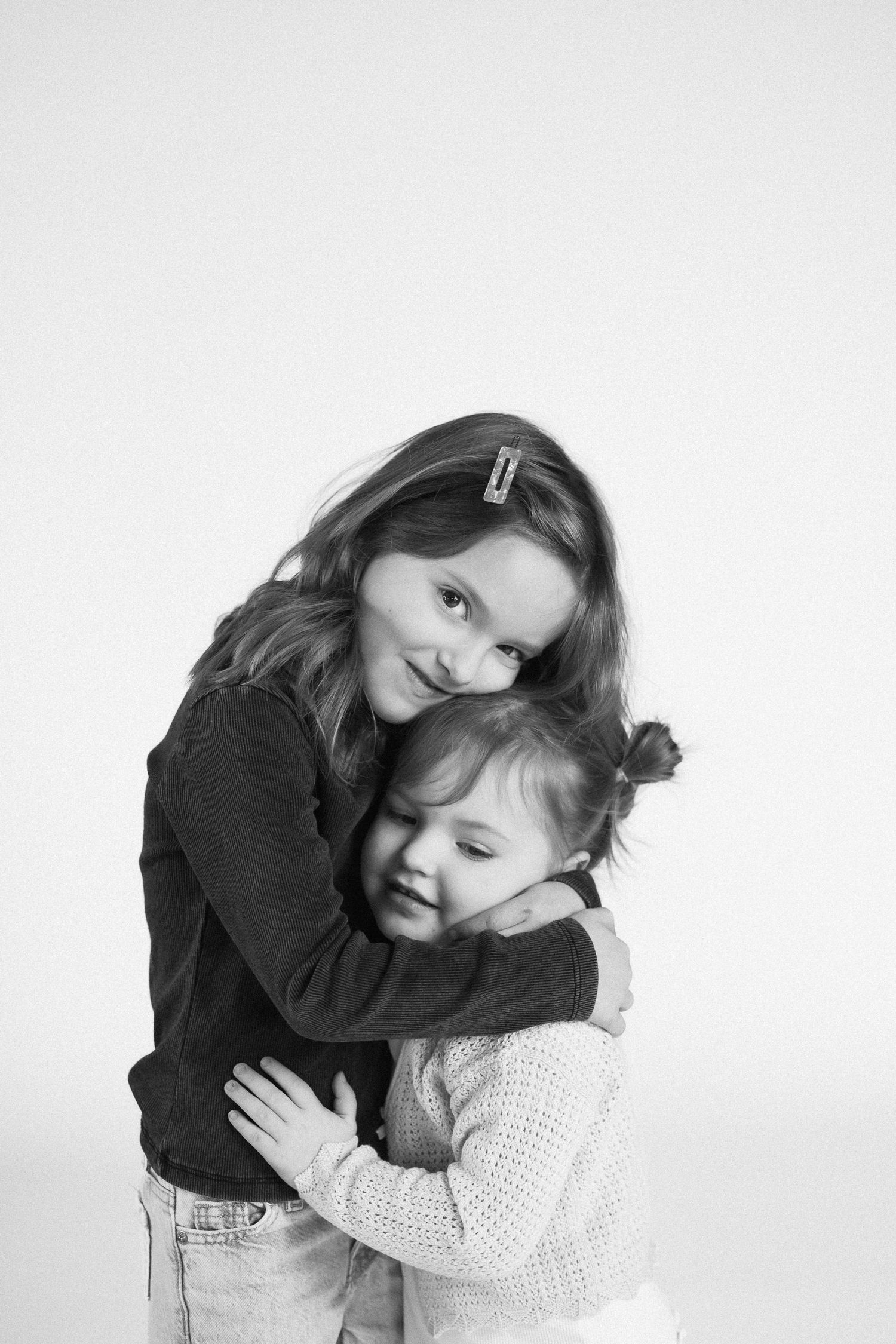 Black and white photo series capturing warm embraces and tender moments.