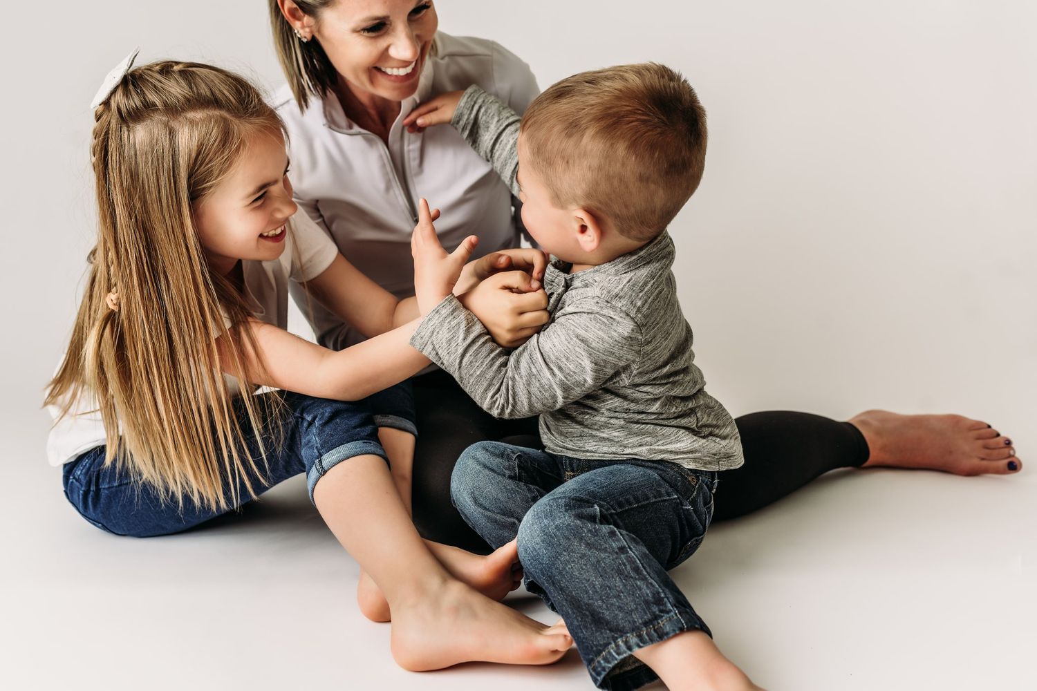 Casual lifestyle portrait showing tender family moment during indoor photo session.