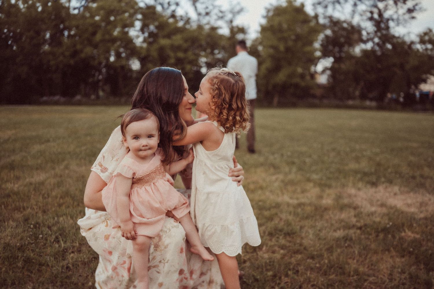 An intimate family portrait showing tender moments of connection during golden hour.