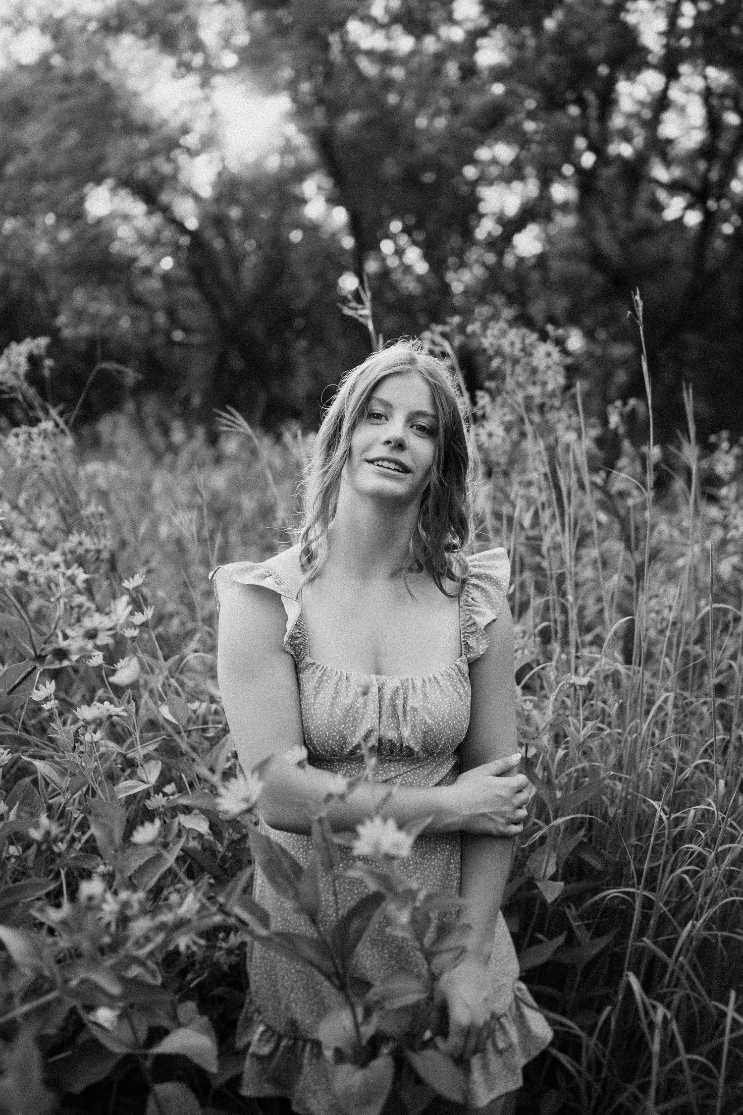 Dreamy black and white portrait surrounded by summer wildflowers and natural light.