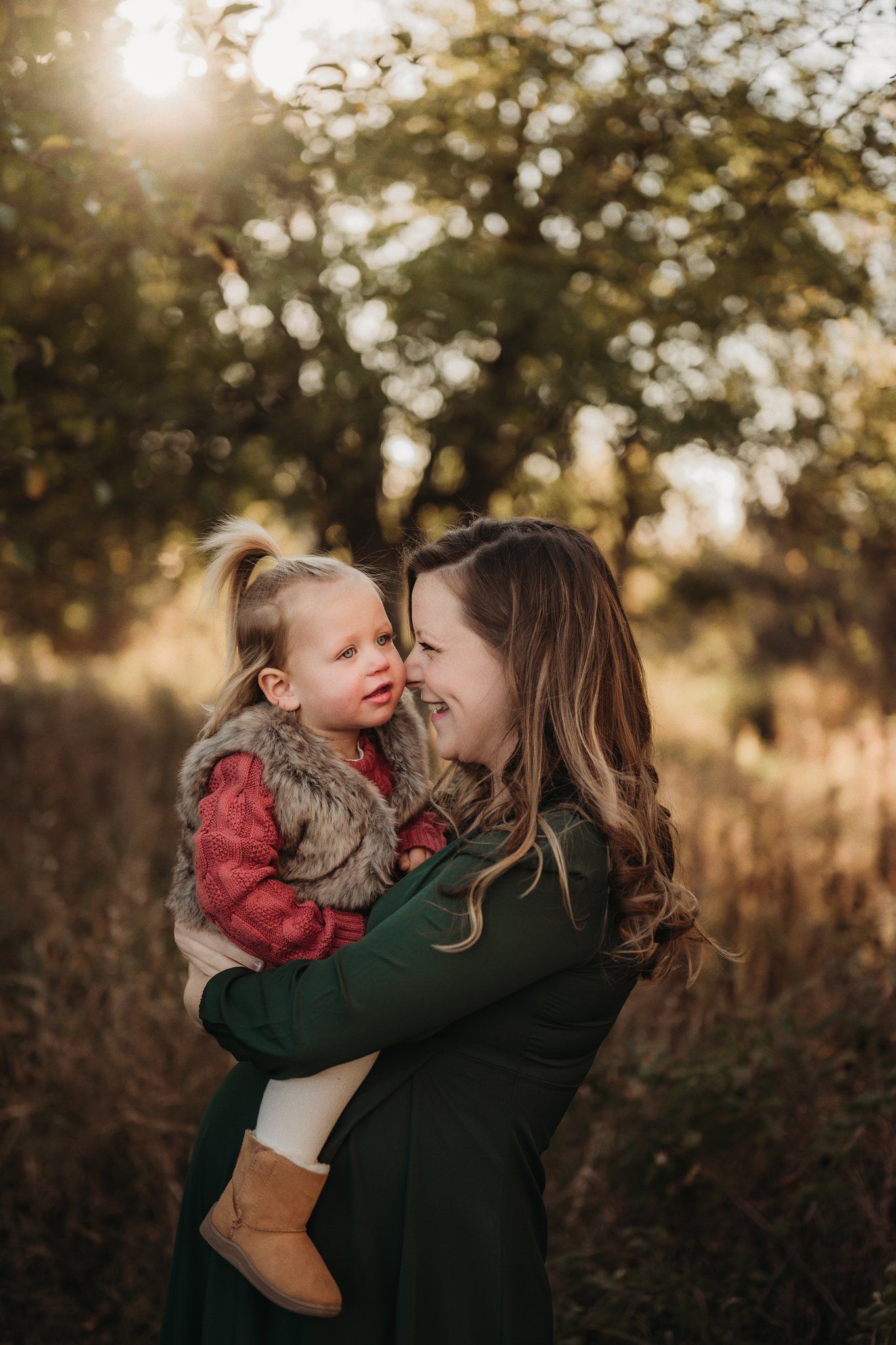 Warm sunset portrait in nature featuring emerald dress and autumn colors.