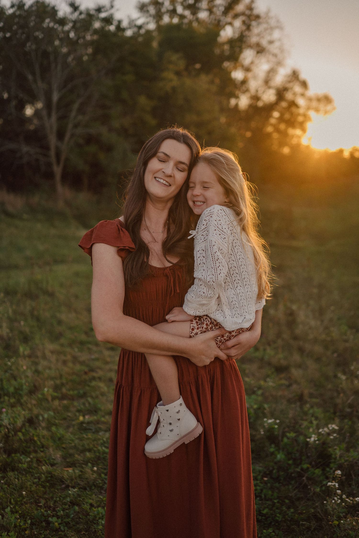 A series of sunset photos showing tender moments between loved ones in a field with warm golden lighting.