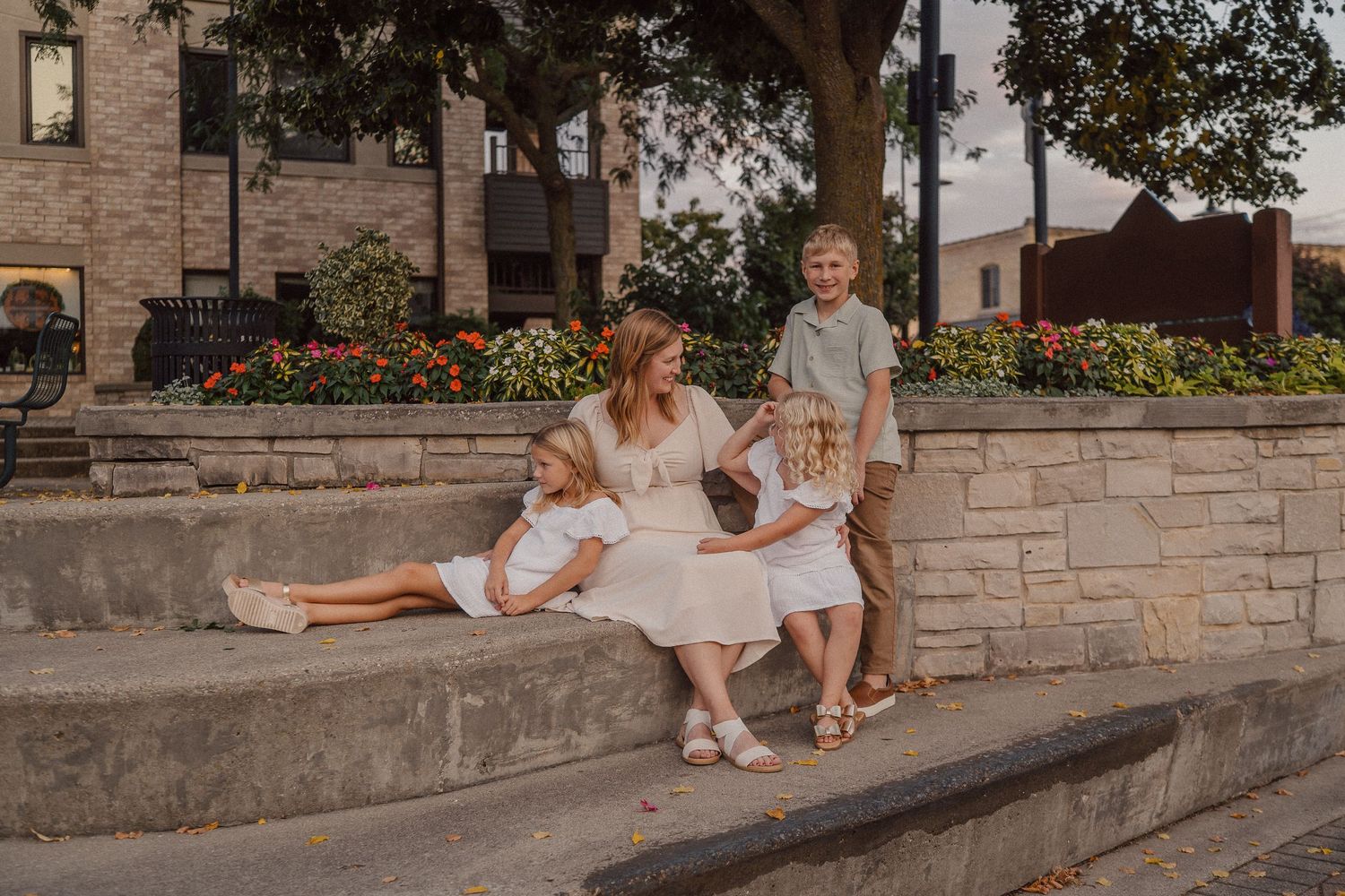 Family sitting together on stone steps outdoors during a casual photo session.