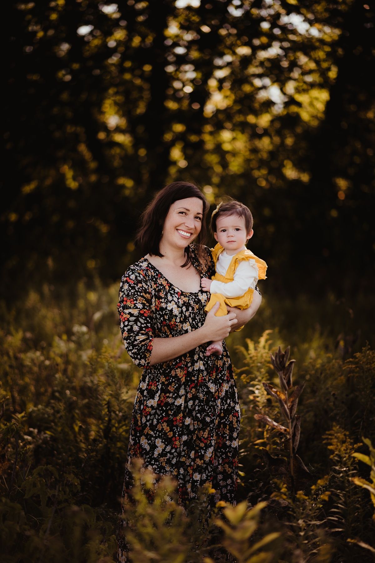 Autumn outdoor portrait in golden light featuring floral dress and yellow outfit.