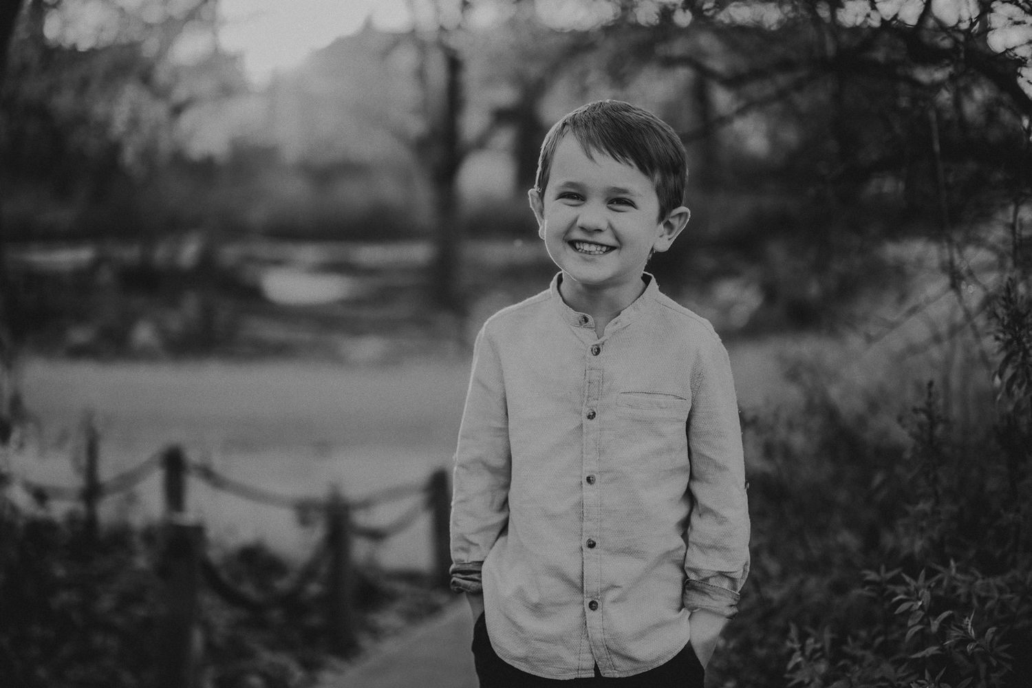Black and white portrait on a park path with natural lighting.