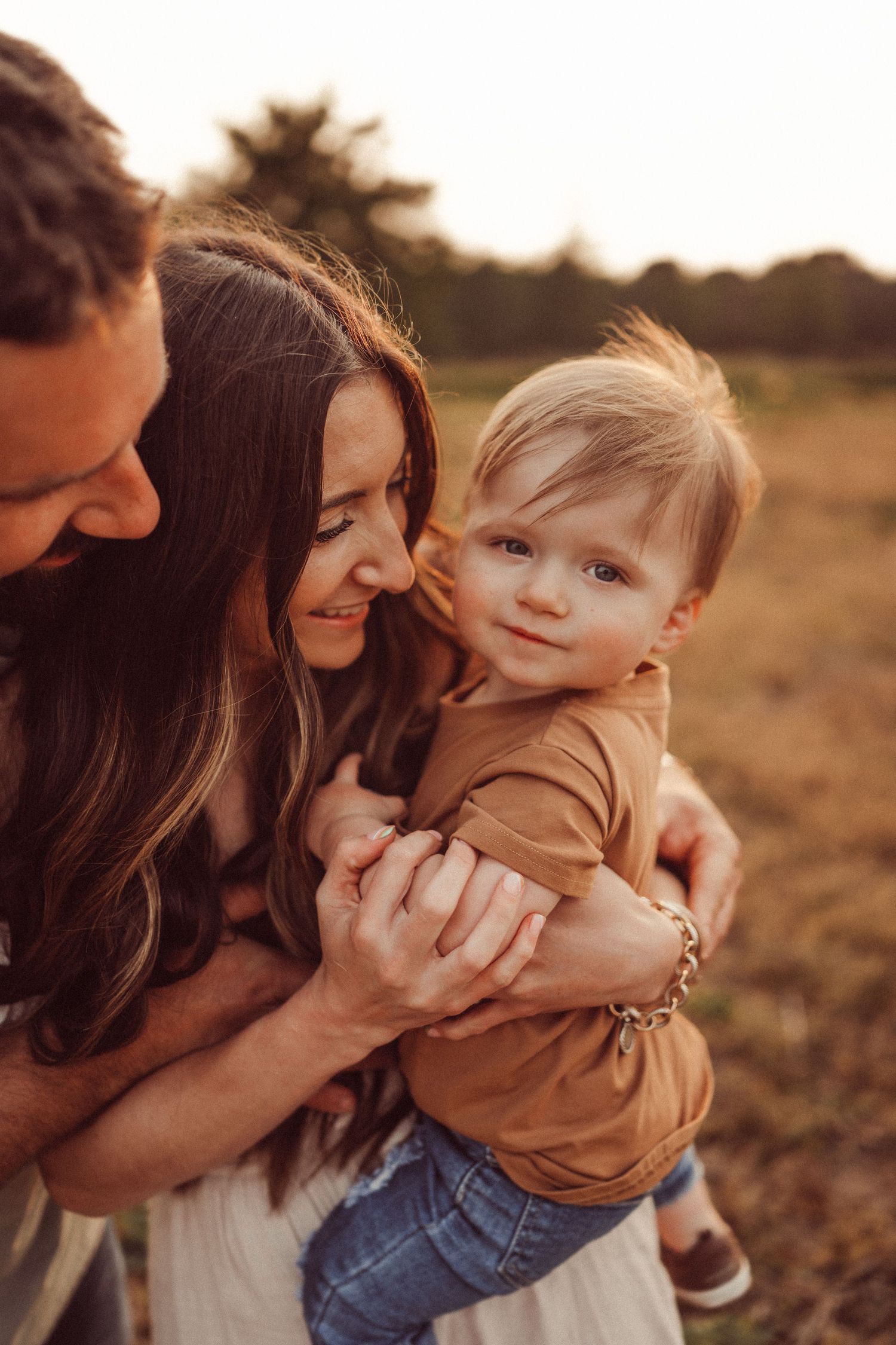 A warm sunset family portrait capturing tender moments of affection.
