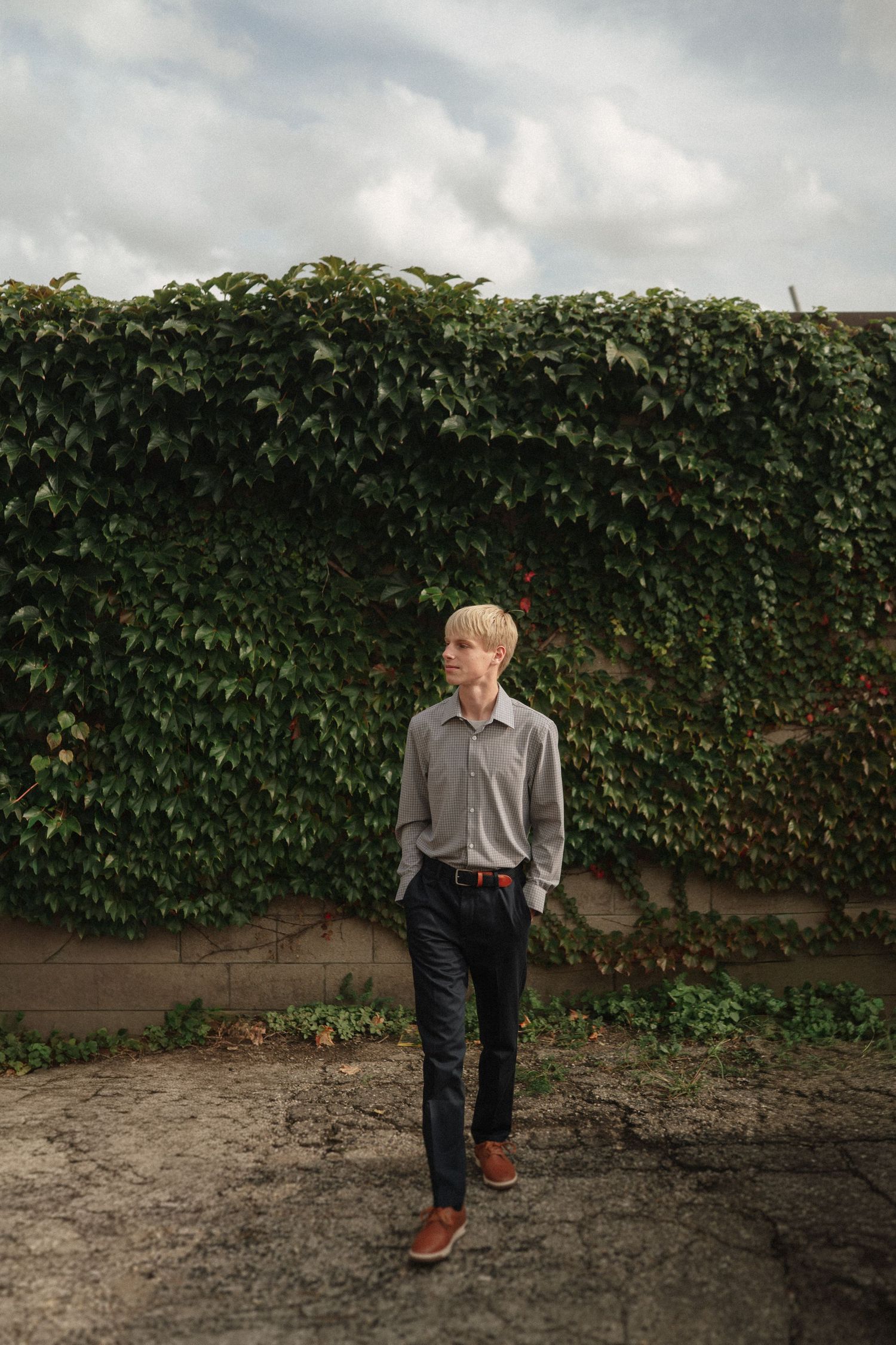 Series of candid poses against an ivy-covered wall showing natural movement and expressions.