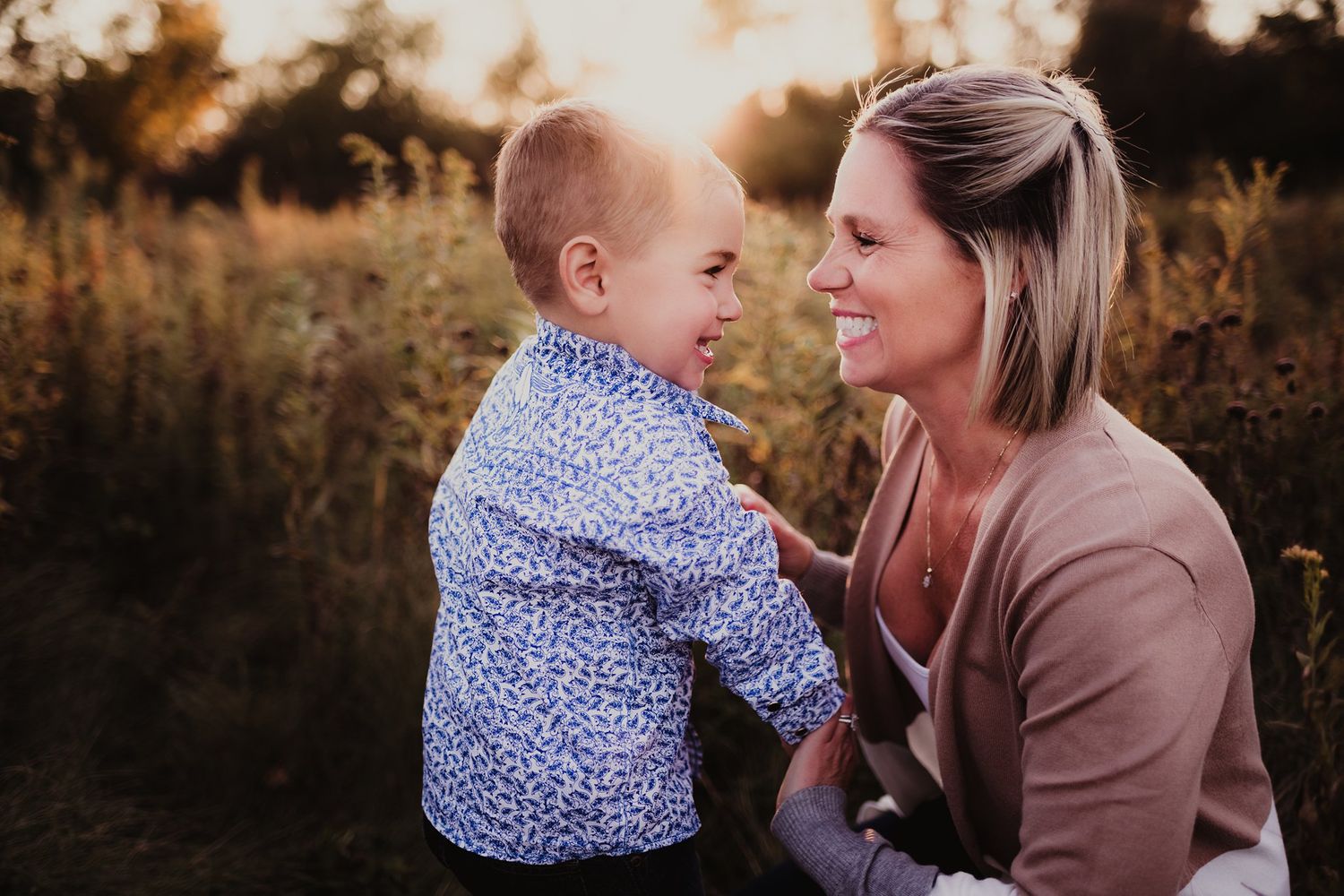 Intimate close-up of adult and child sharing a special moment in natural setting.