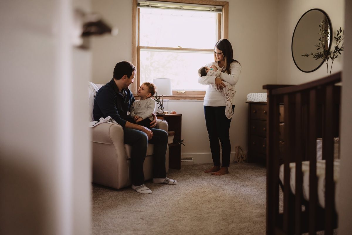 Indoor lifestyle photo of family spending time together in a cozy living room.