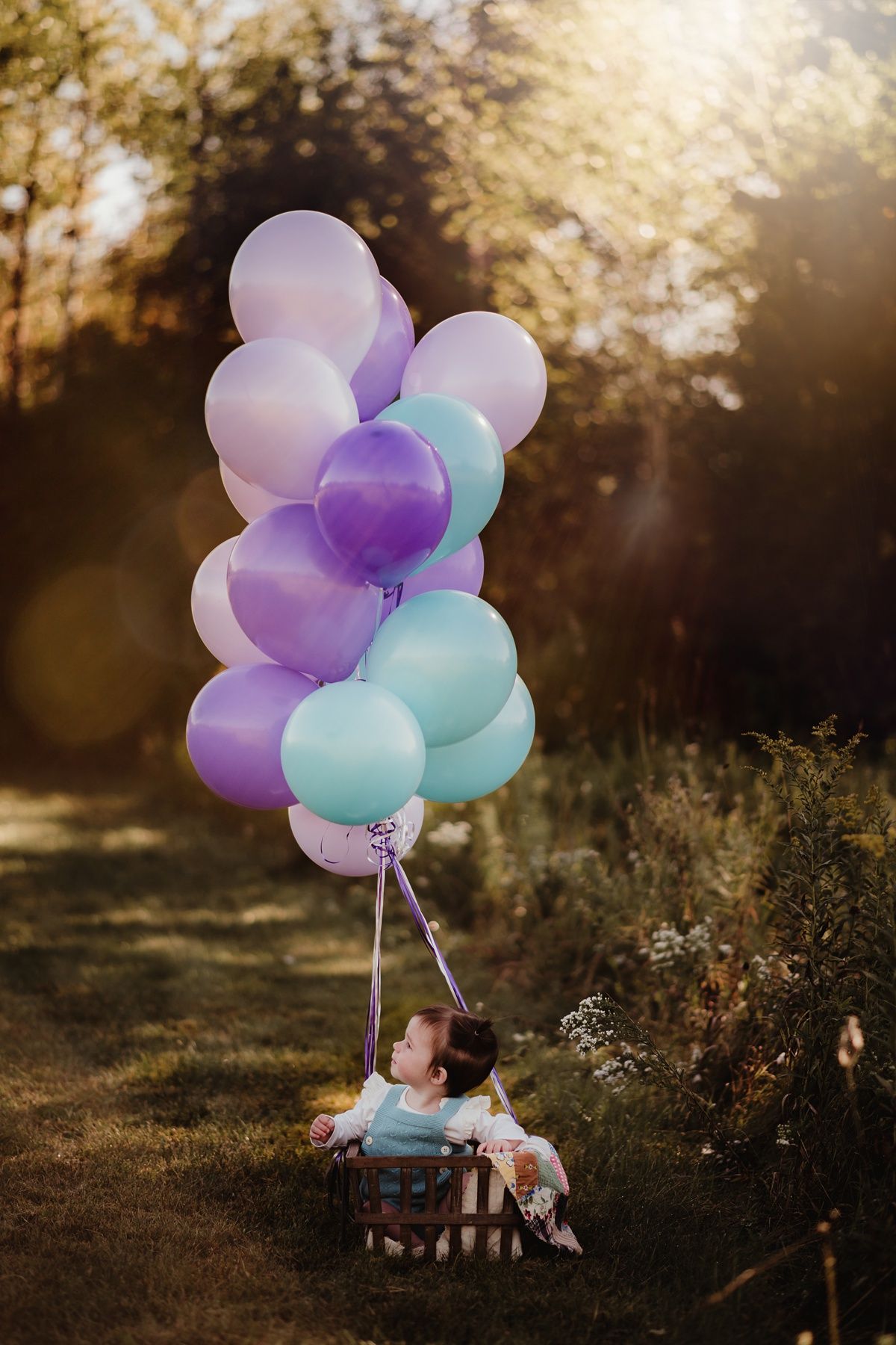 Whimsical scene with turquoise and purple balloons in autumn setting.